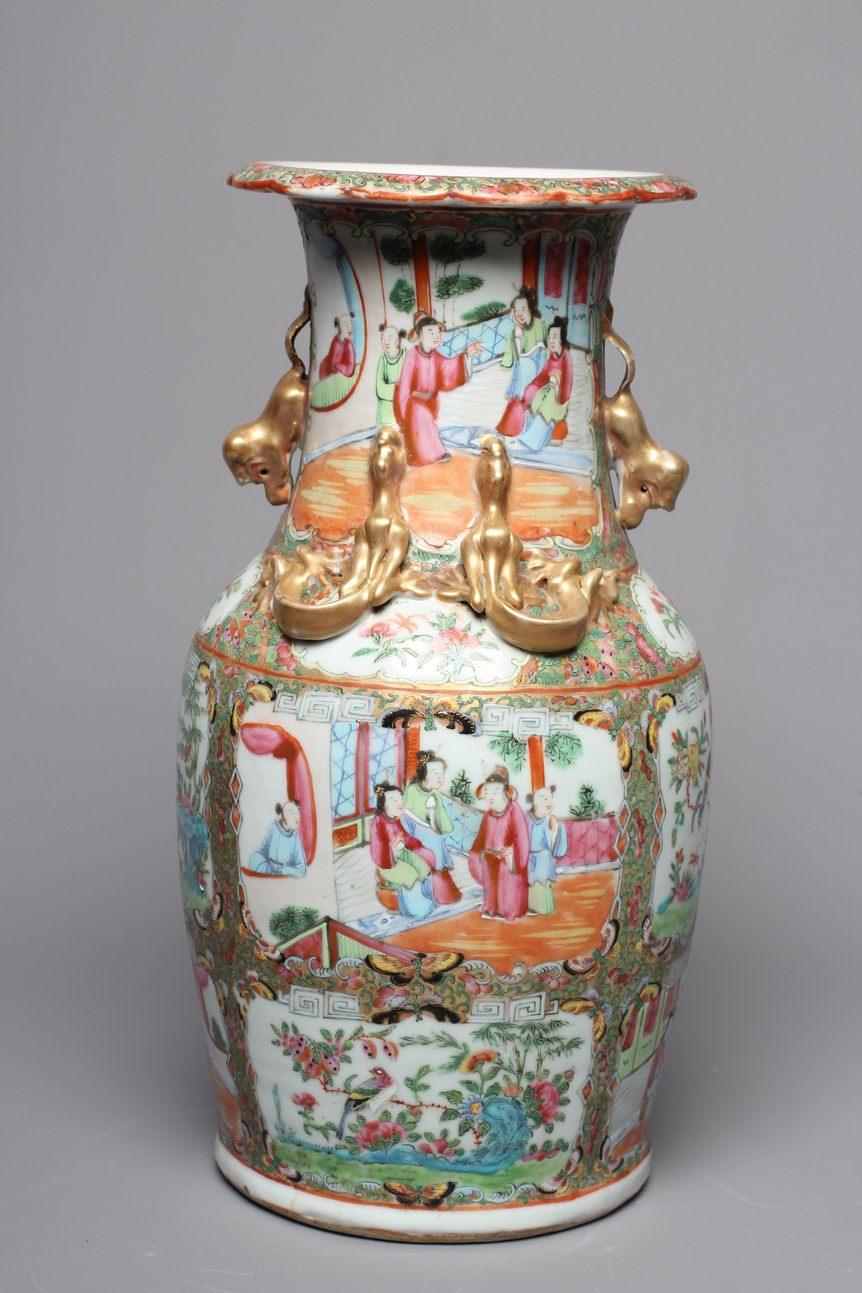 A CANTONESE FAMILLE ROSE PORCELAIN VASE of baluster form with everted rim, chi-long handles and Image