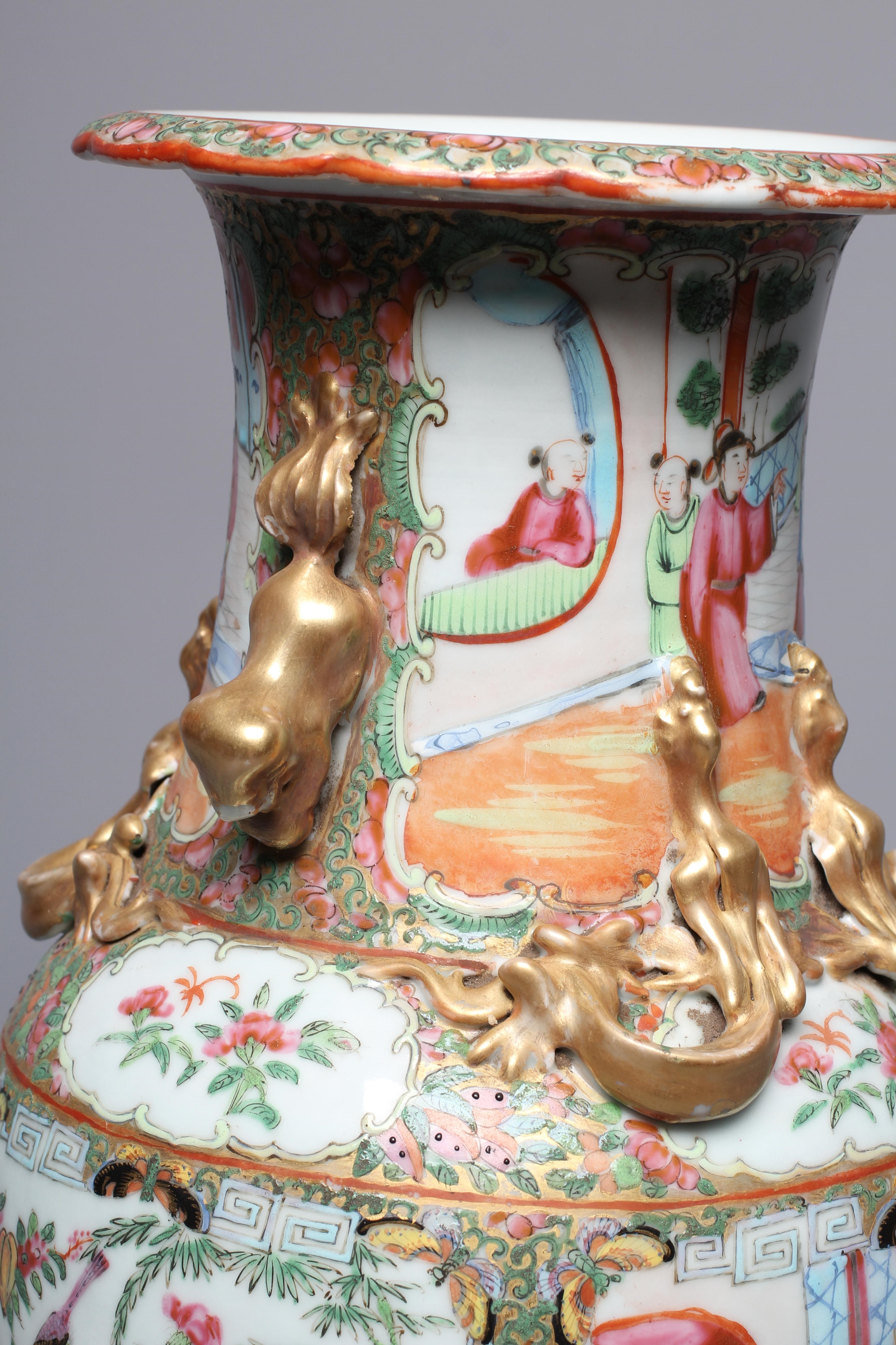 A CANTONESE FAMILLE ROSE PORCELAIN VASE of baluster form with everted rim, chi-long handles and Image