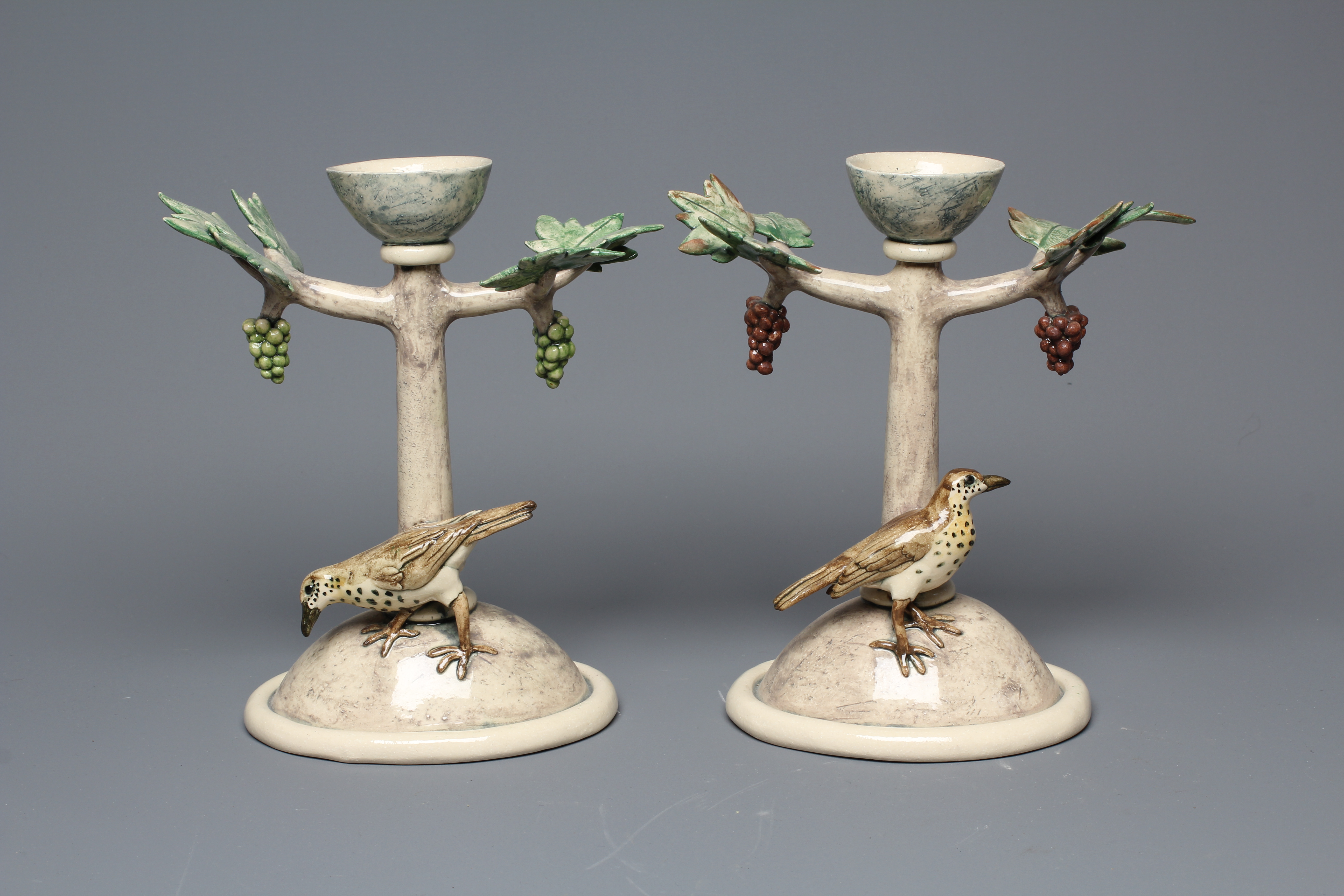 ANNA LAMBERT (B.1957) A PAIR OF SLIPWARE CANDLESTICKS modelled as stylised fruiting vines on high Image