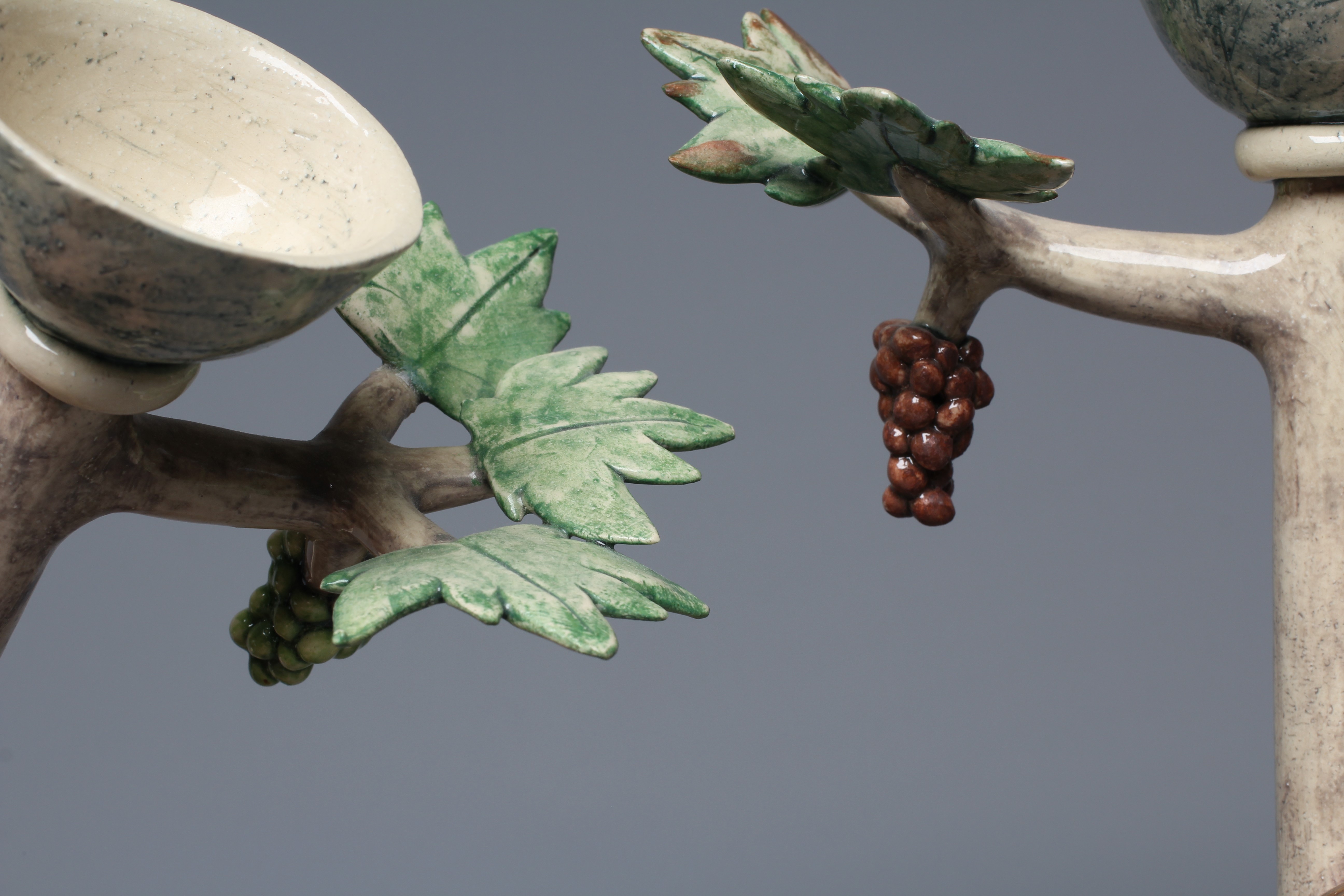 ANNA LAMBERT (B.1957) A PAIR OF SLIPWARE CANDLESTICKS modelled as stylised fruiting vines on high Image