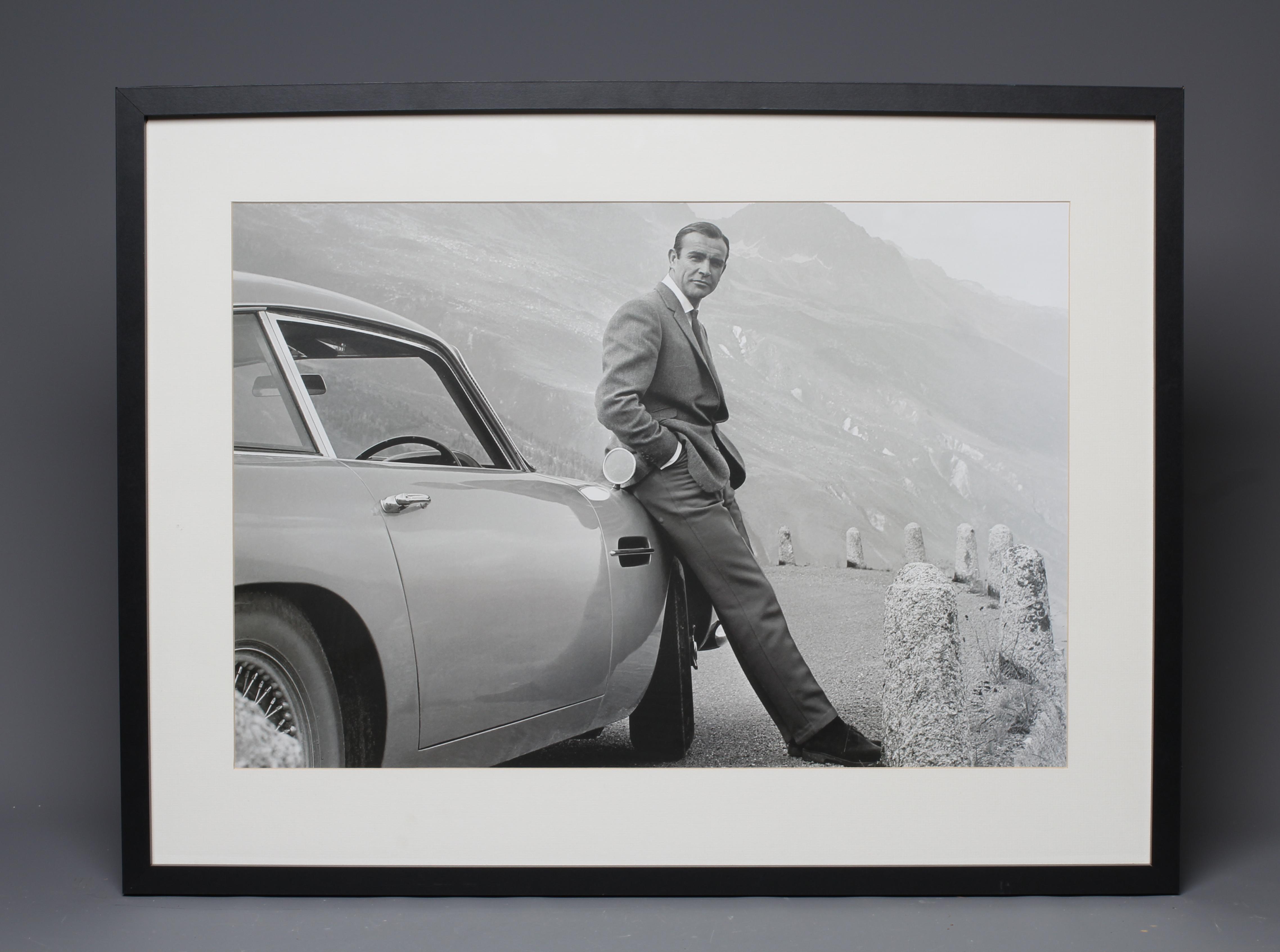 A 21ST CENTURY POSTER OF THE ICONIC ASTON MARTIN DB5 AND SEAN CONNERY 007, 17 1/2" x 25 3/4", framed Image