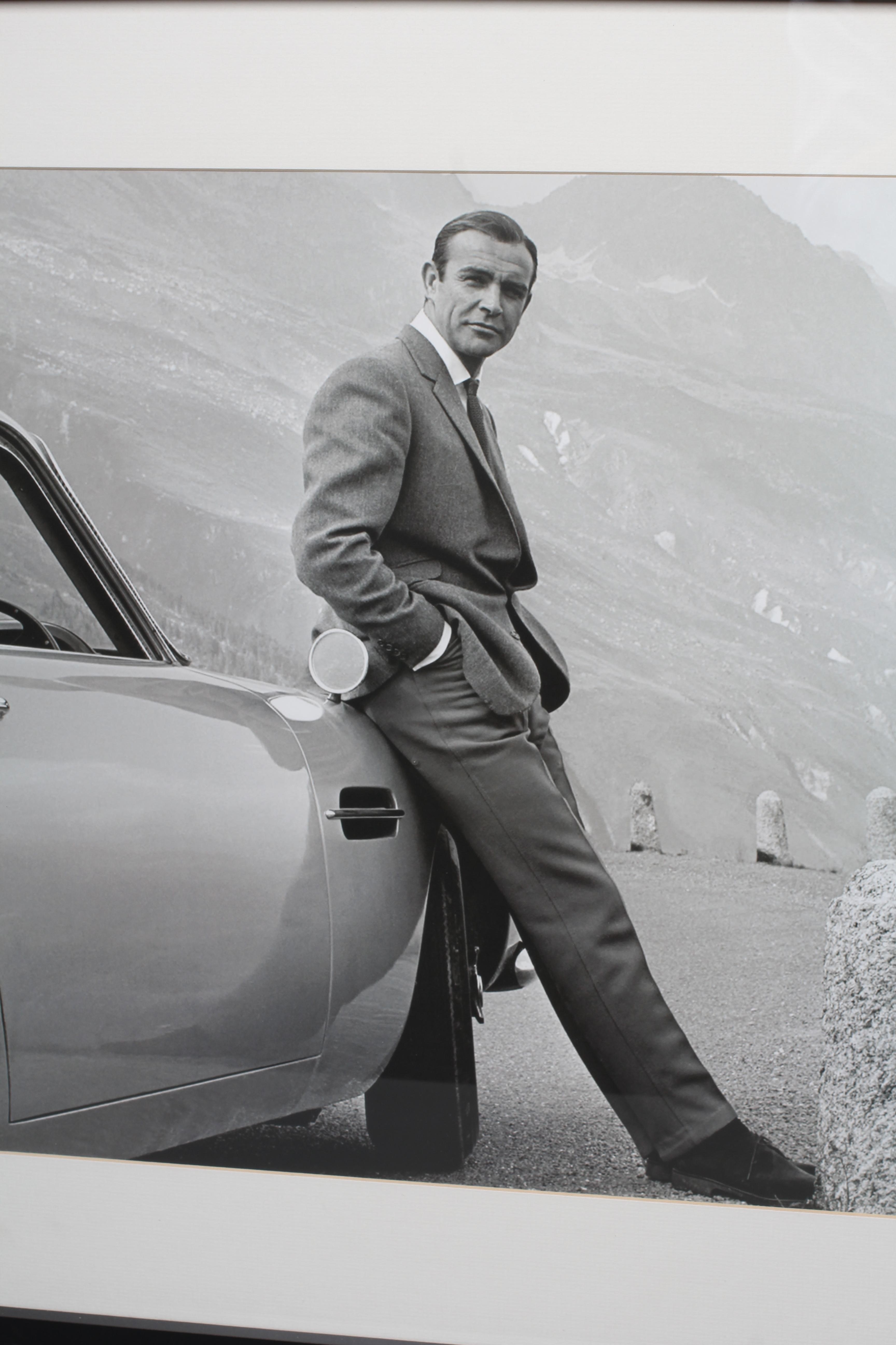 A 21ST CENTURY POSTER OF THE ICONIC ASTON MARTIN DB5 AND SEAN CONNERY 007, 17 1/2" x 25 3/4", framed Image