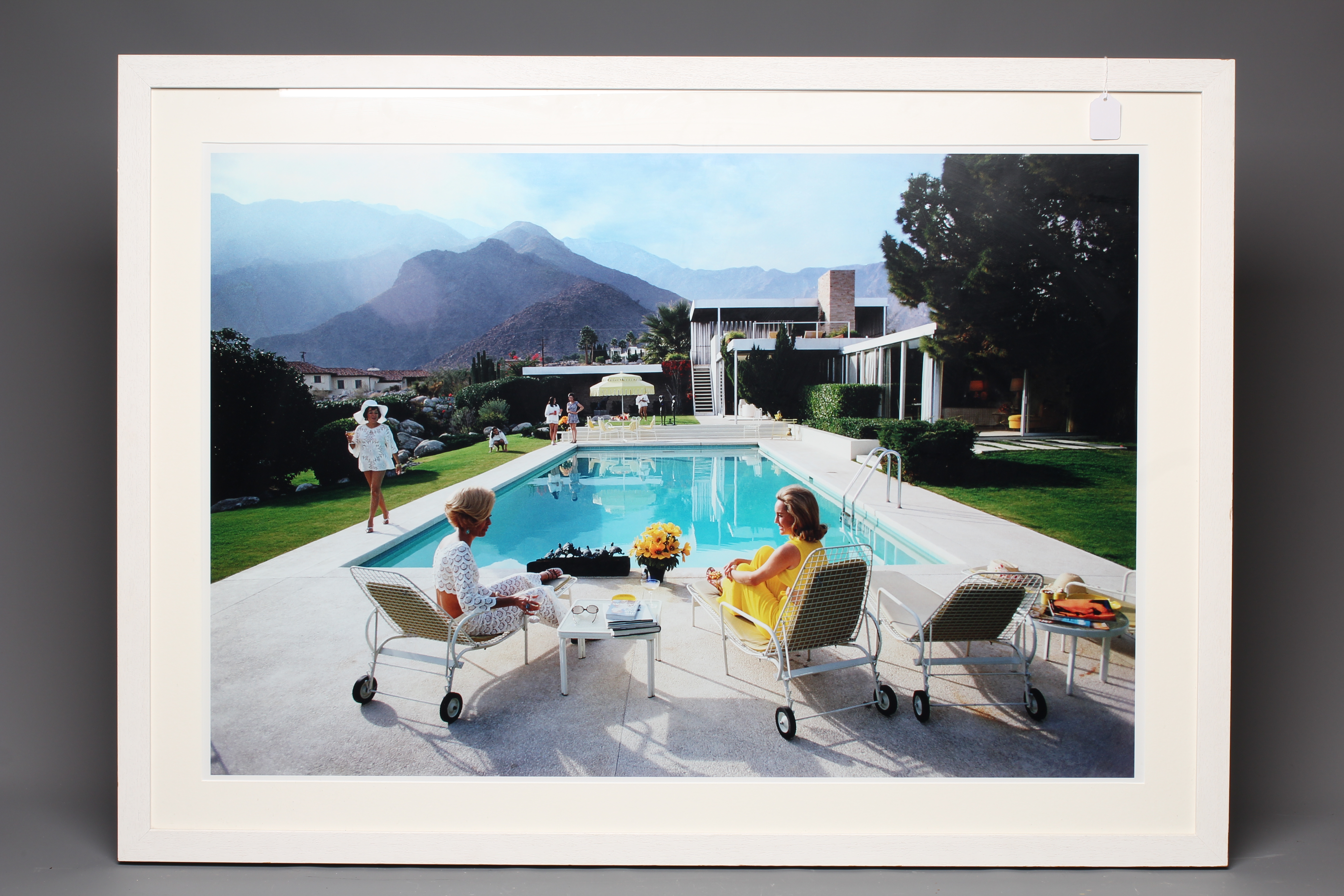 AFTER SLIM AARONS (1916-2000) Poolside Gossip (1970), photographic print, 26" x 38 1/2" (SH), framed Image