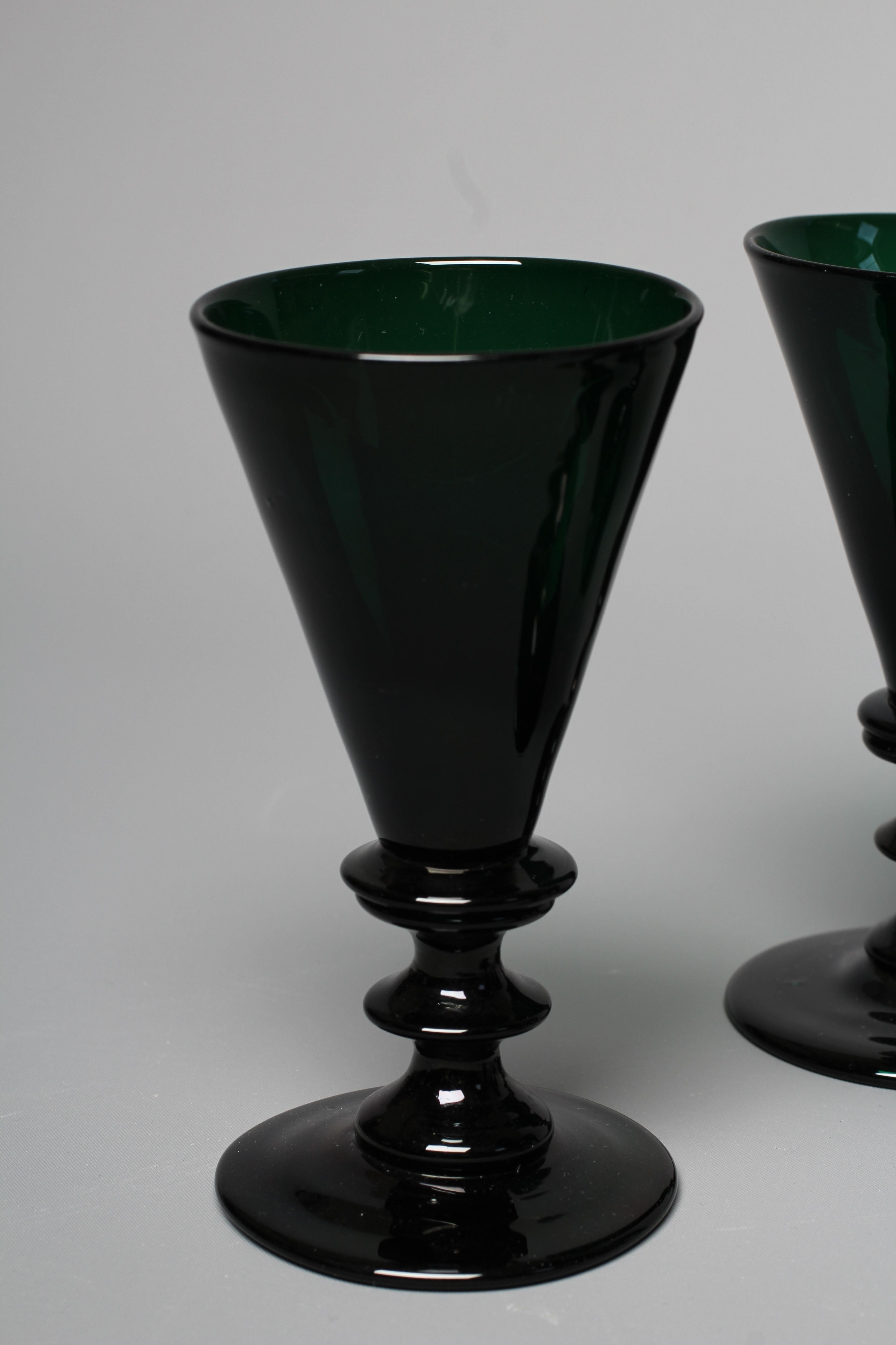 A SET OF SIX BRISTOL GREEN GLASS FLUTES, early 19th century, the conical bowls issuing from double Image