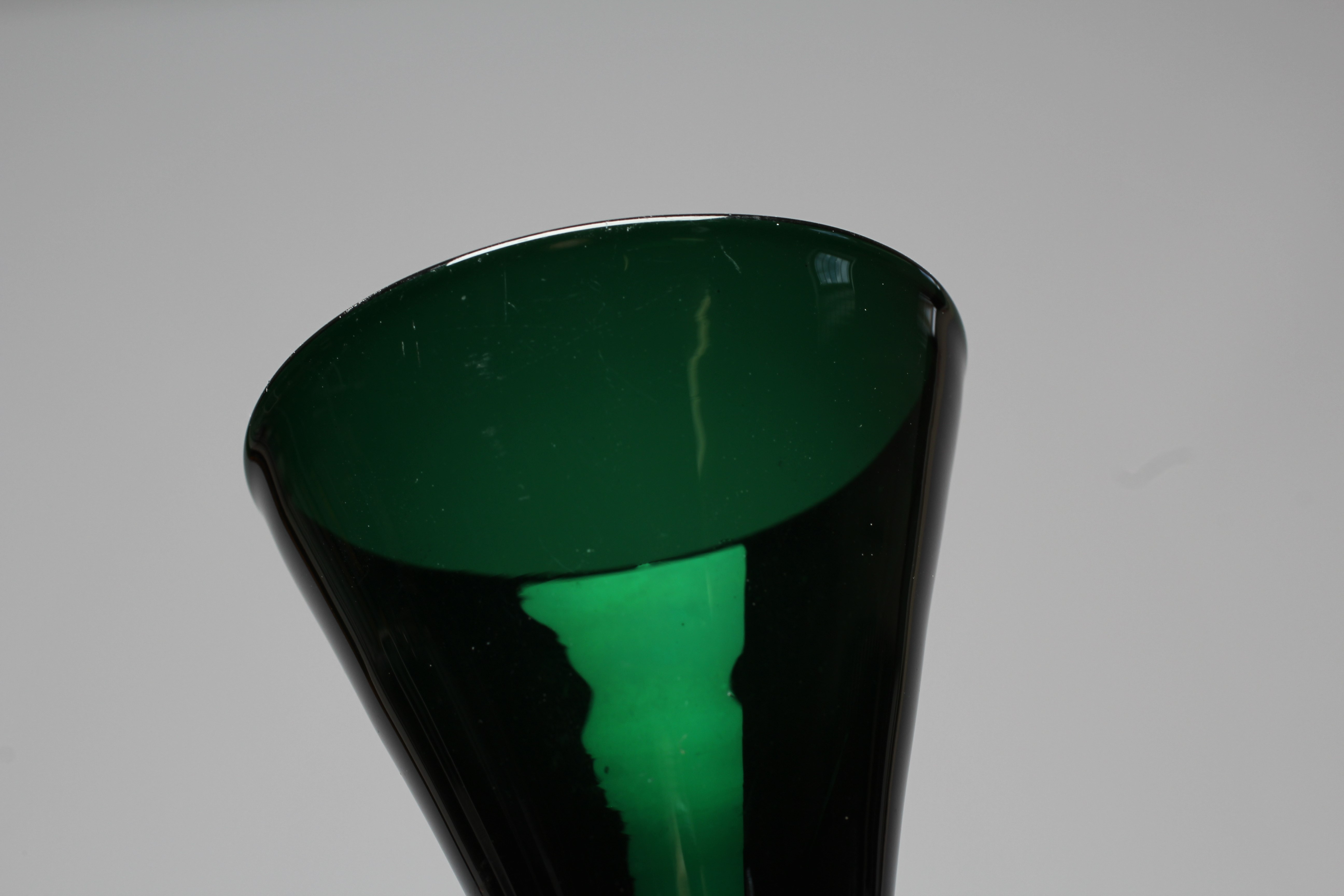 A SET OF SIX BRISTOL GREEN GLASS FLUTES, early 19th century, the conical bowls issuing from double Image