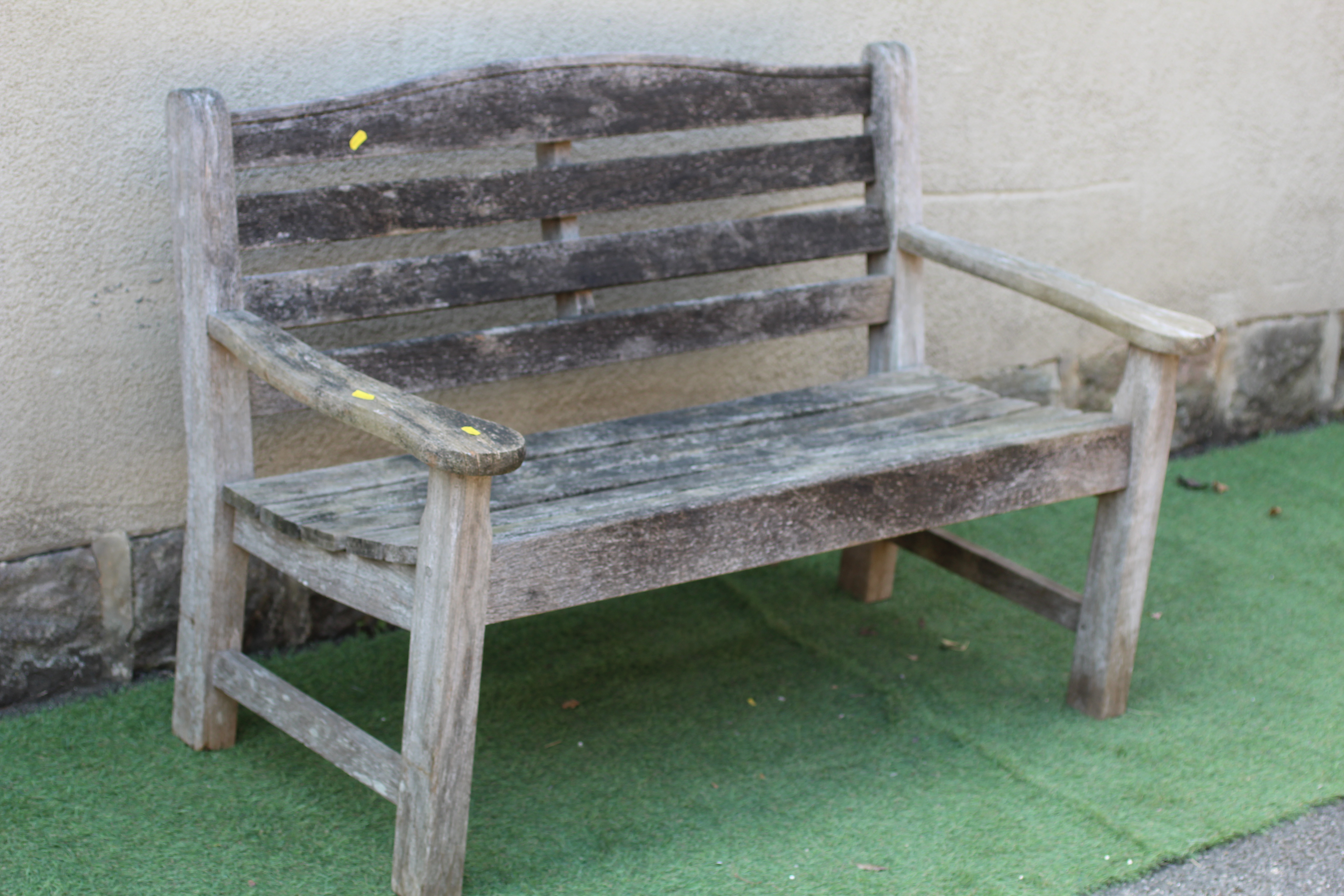 A SLATTED TEAK BENCH, with mildly arched back, with mildly arched back, scrolled arms and square Image