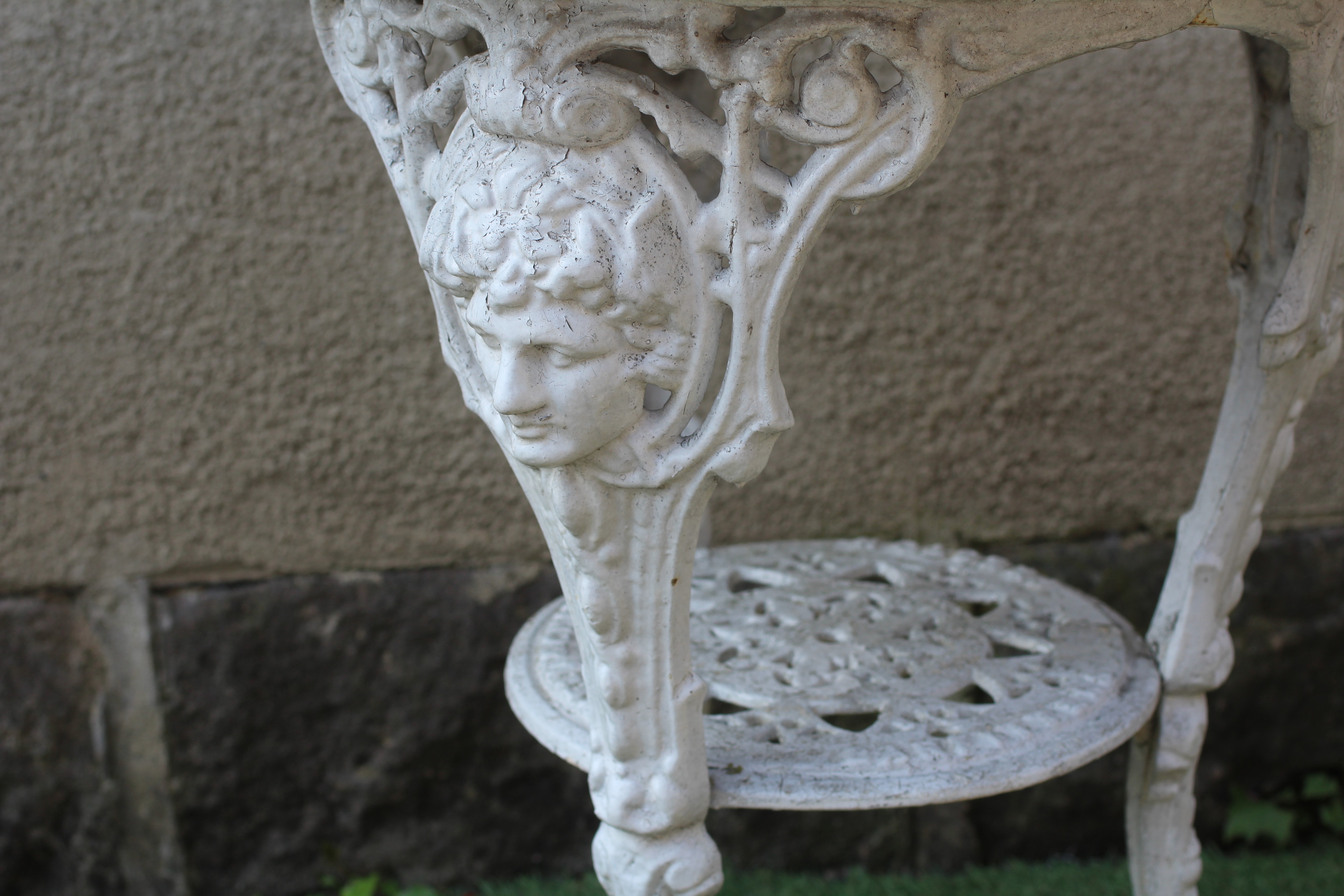 A VICTORIAN CAST IRON PUB TABLE with circular wood top, the mask headed cabriole legs with scroll Image