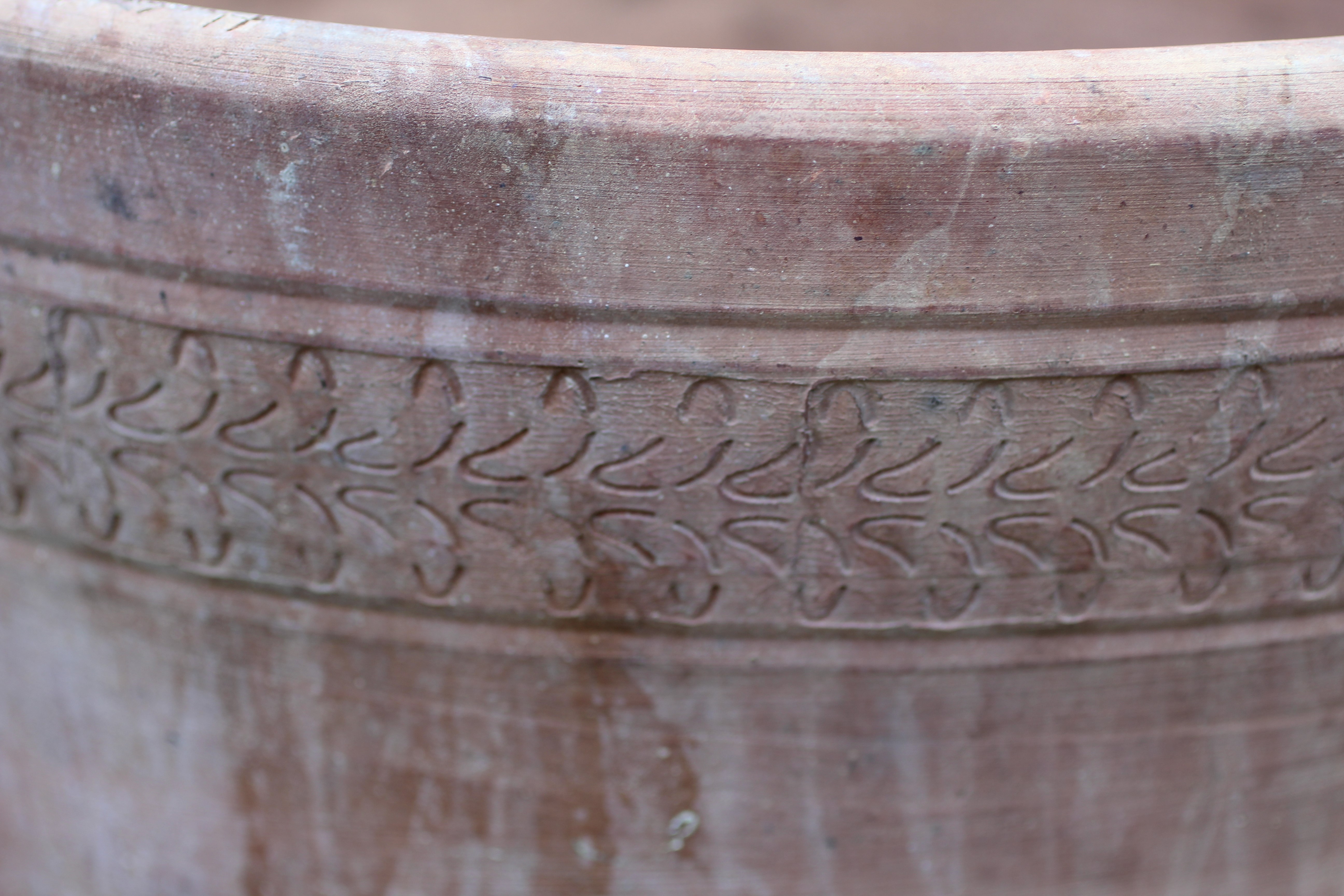 A SET OF THREE TERRACOTTA PLANT POTS, modern, of tapering form with leaf banded rim, inscribed Image