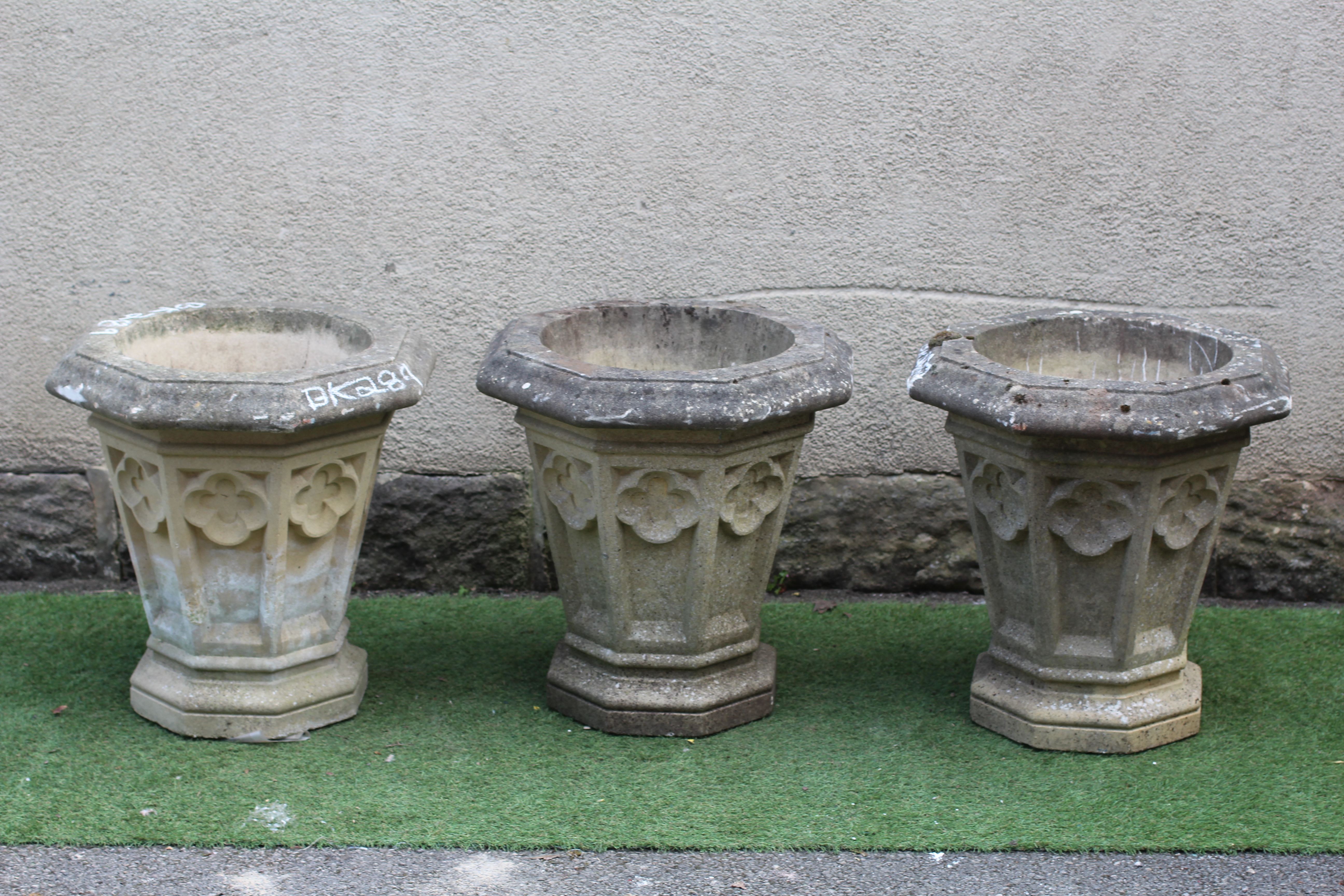 A SET OF THREE GOTHIC PLANTERS to match previous lots Image