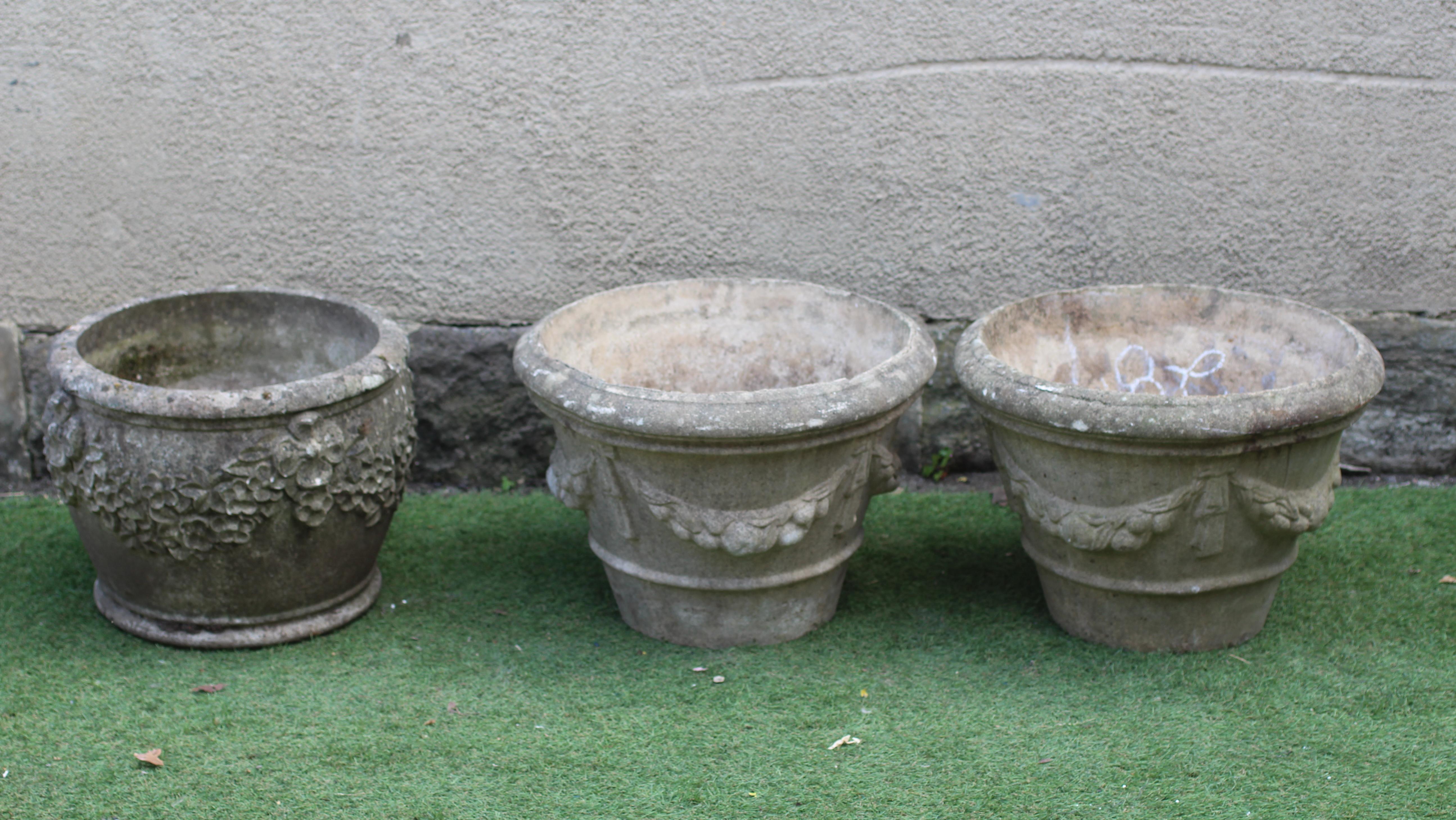 A PAIR OF CAST STONE PLANTERS, modern, of tapering form with ribbon tied fruiting swags in high Image