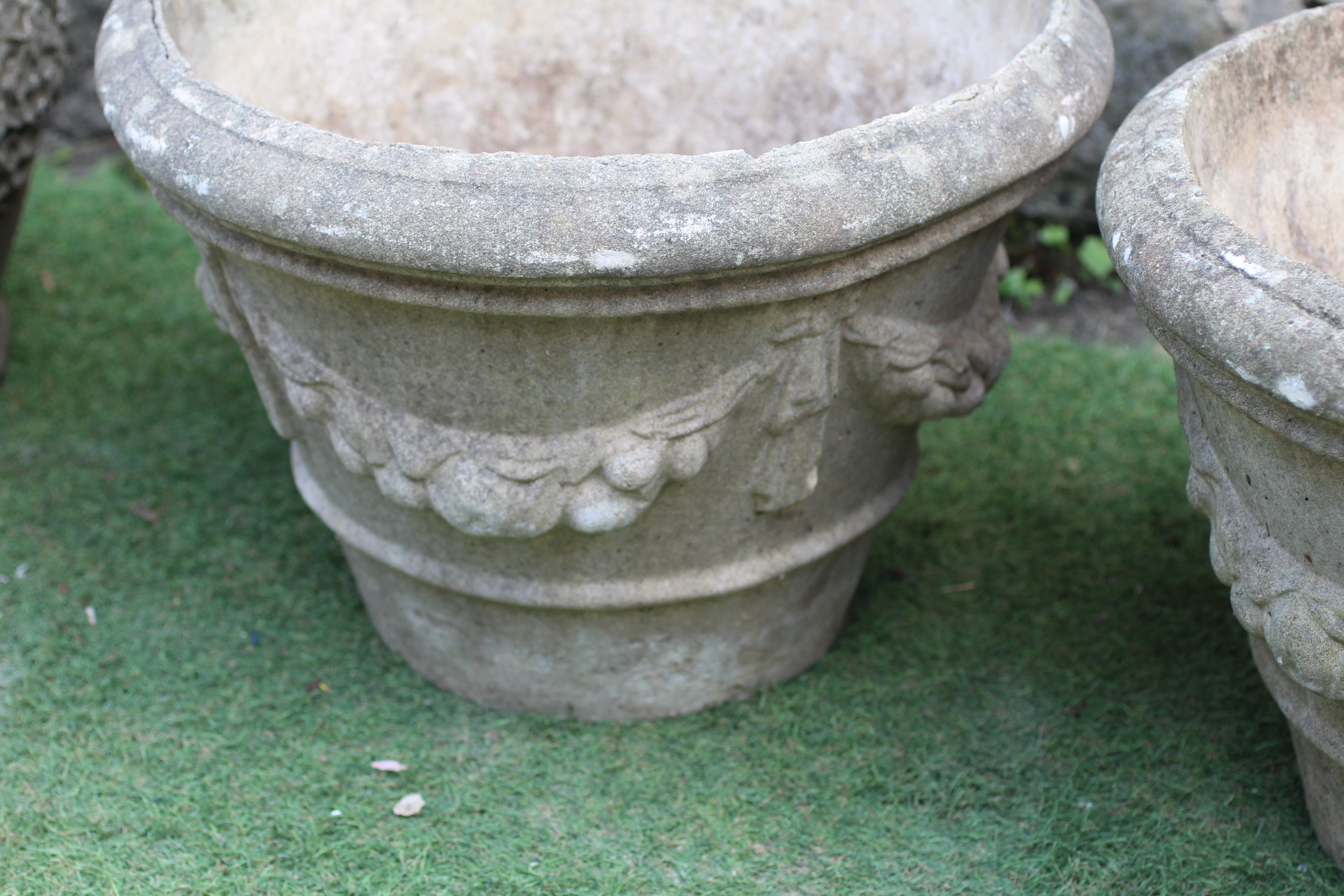 A PAIR OF CAST STONE PLANTERS, modern, of tapering form with ribbon tied fruiting swags in high Image