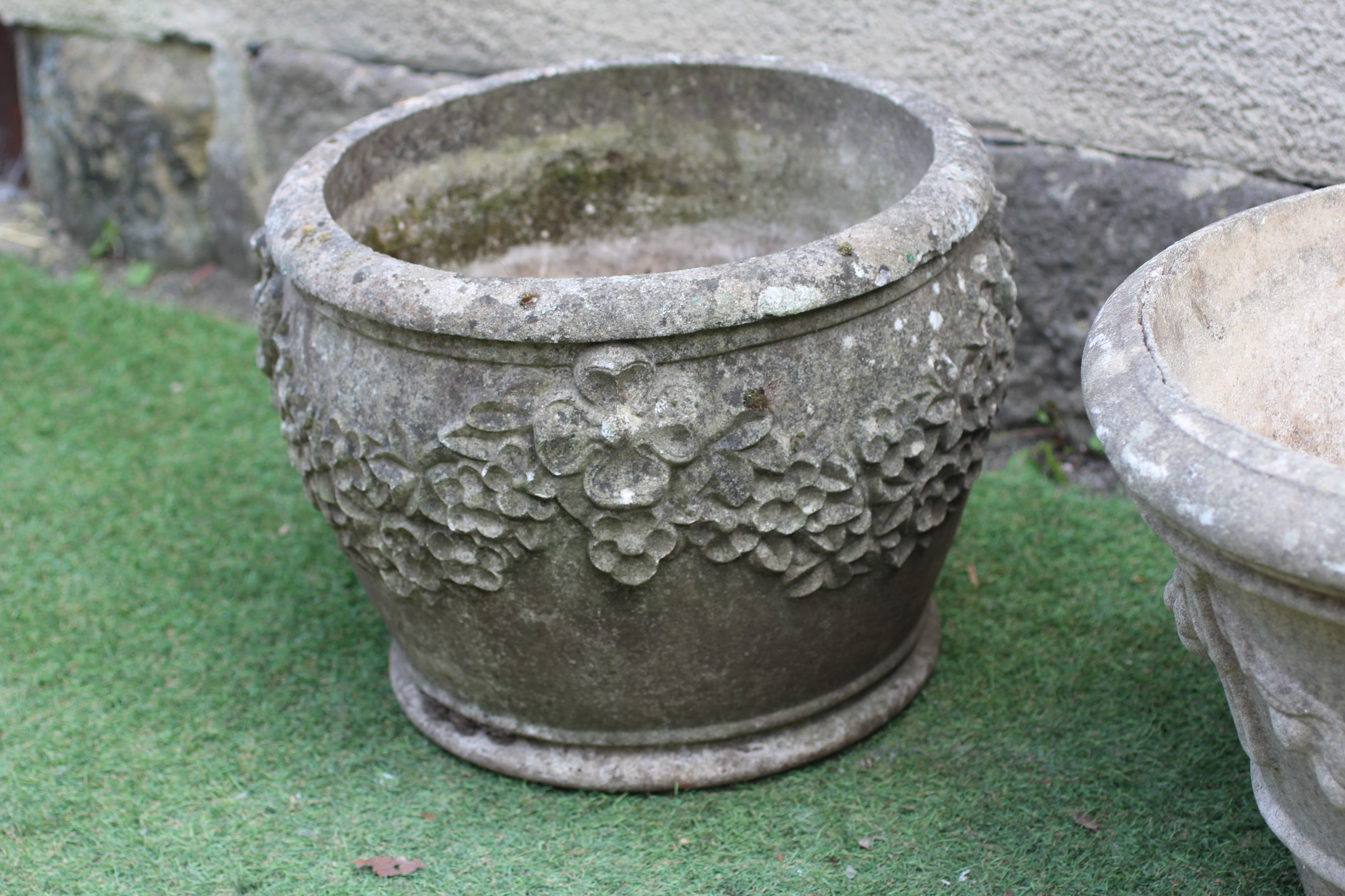 A PAIR OF CAST STONE PLANTERS, modern, of tapering form with ribbon tied fruiting swags in high Image