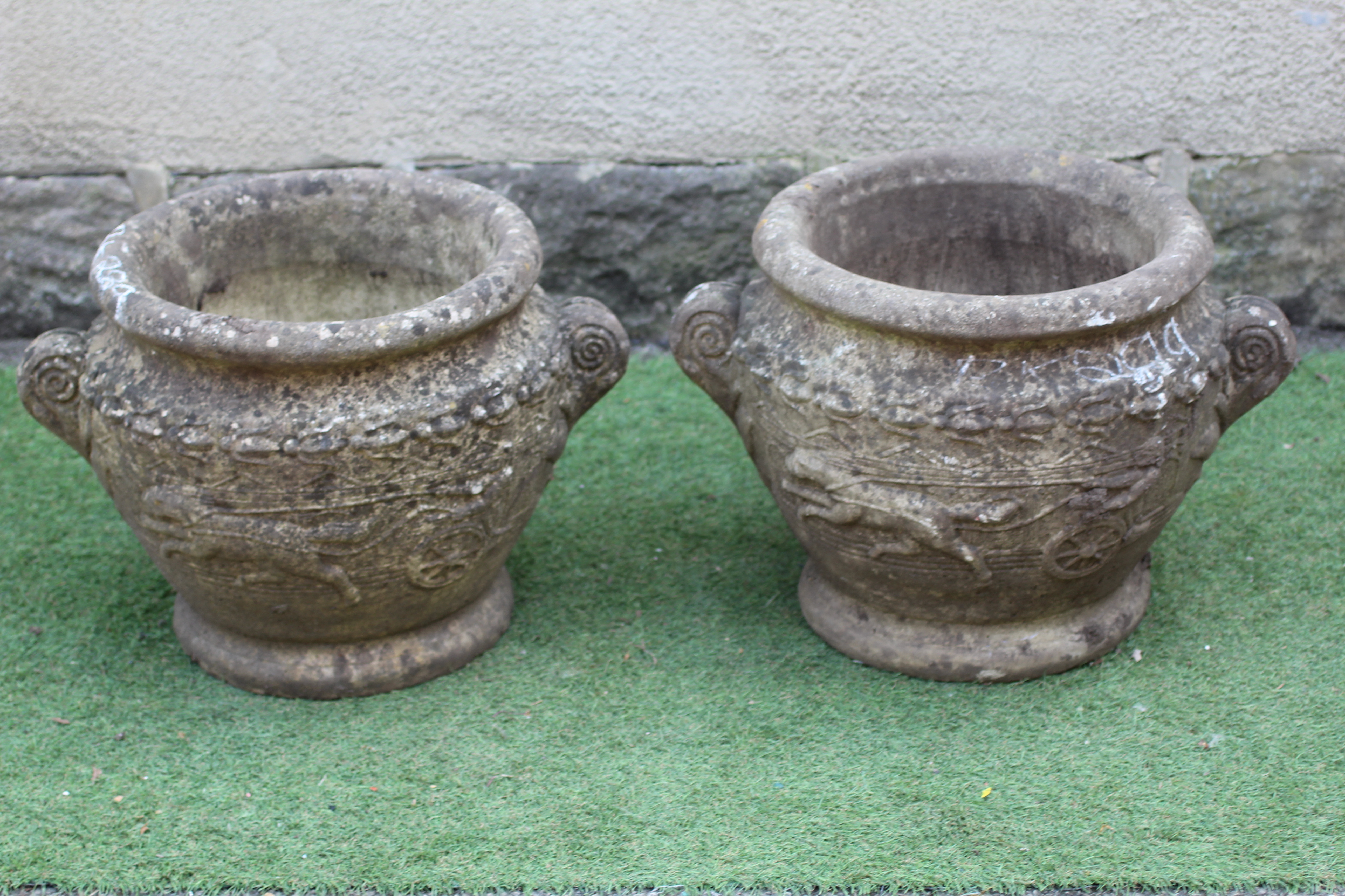 A PAIR OF CAST STONE PLANTERS, modern, of tapering form with fold over rims and foliate scroll Image