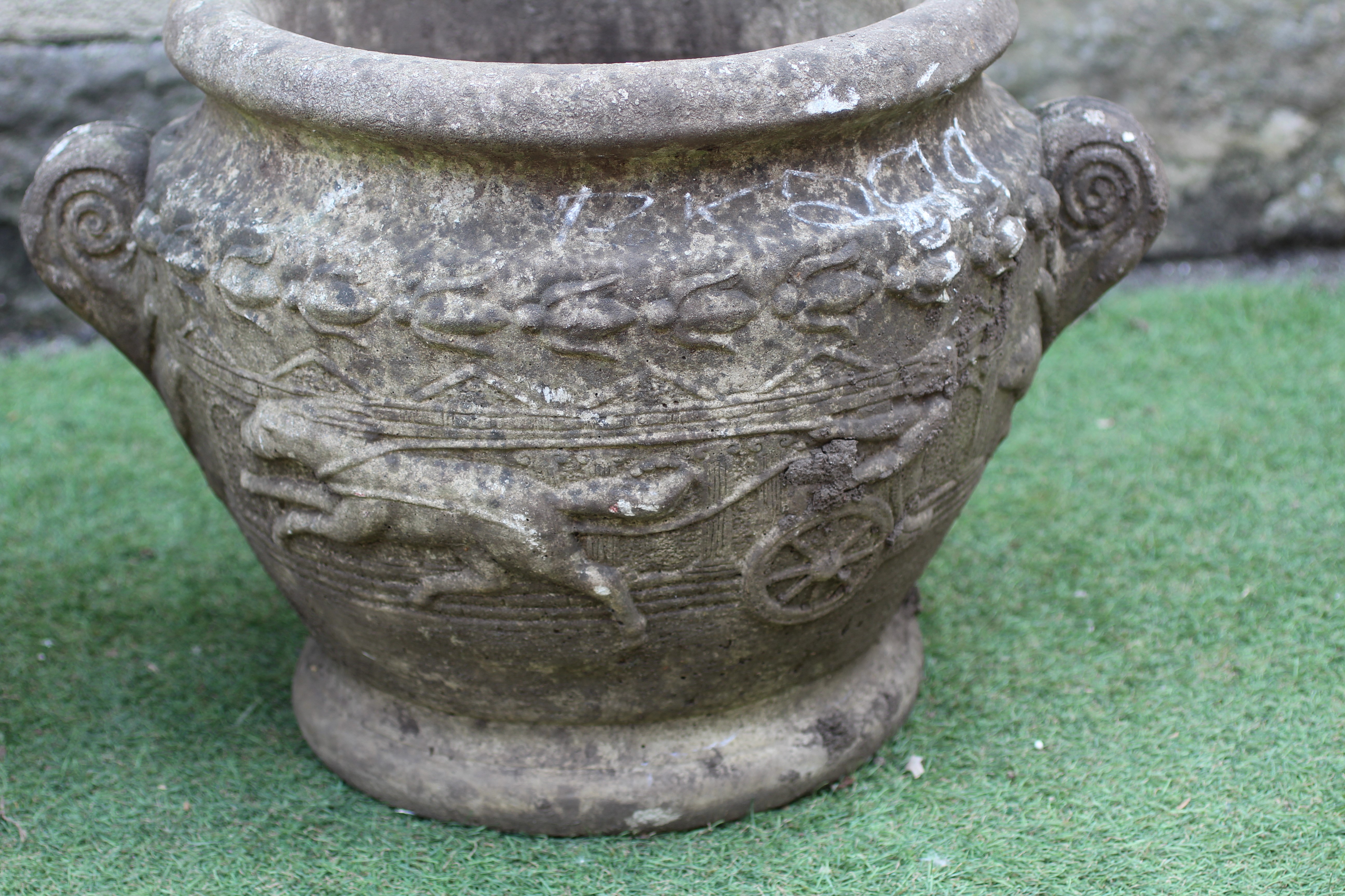 A PAIR OF CAST STONE PLANTERS, modern, of tapering form with fold over rims and foliate scroll Image