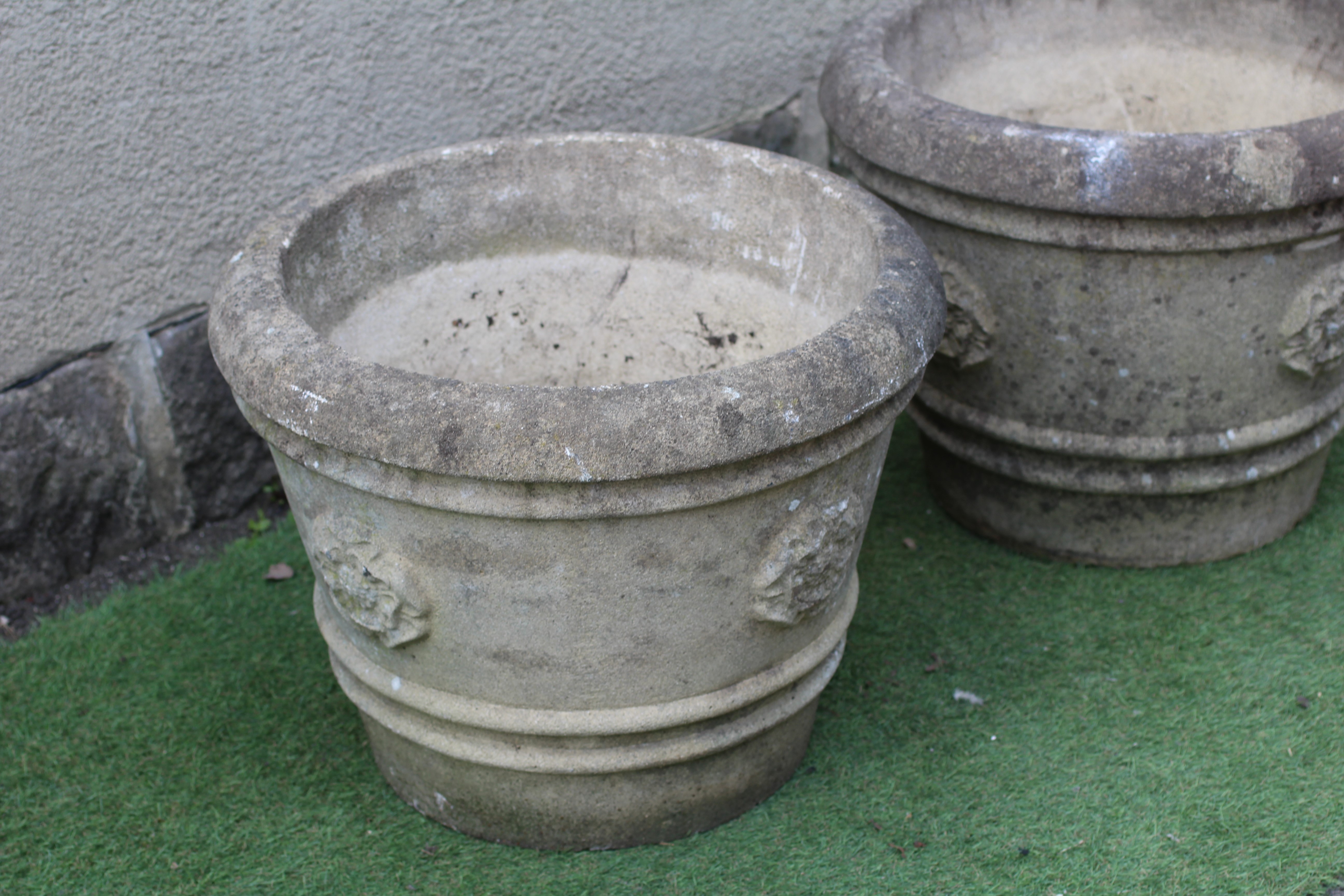 A PAIR OF CAST STONE URNS, modern, the ribbed tapering sides with Yorkshire roses in relief, 22 1/2" Image