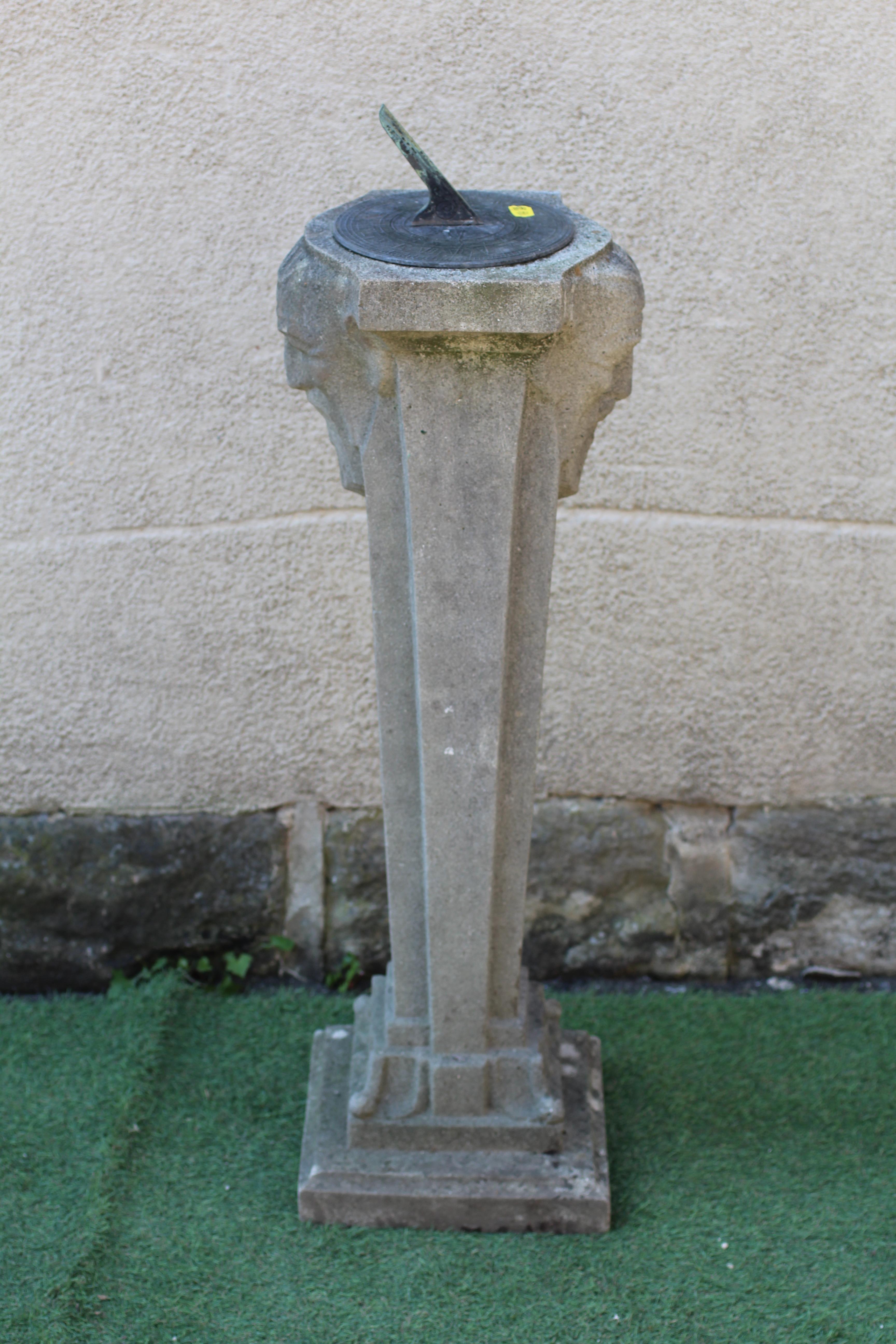 A CAST STONE SUNDIAL, the metal gnomon raised on square tapering column with bearded male mask to Image