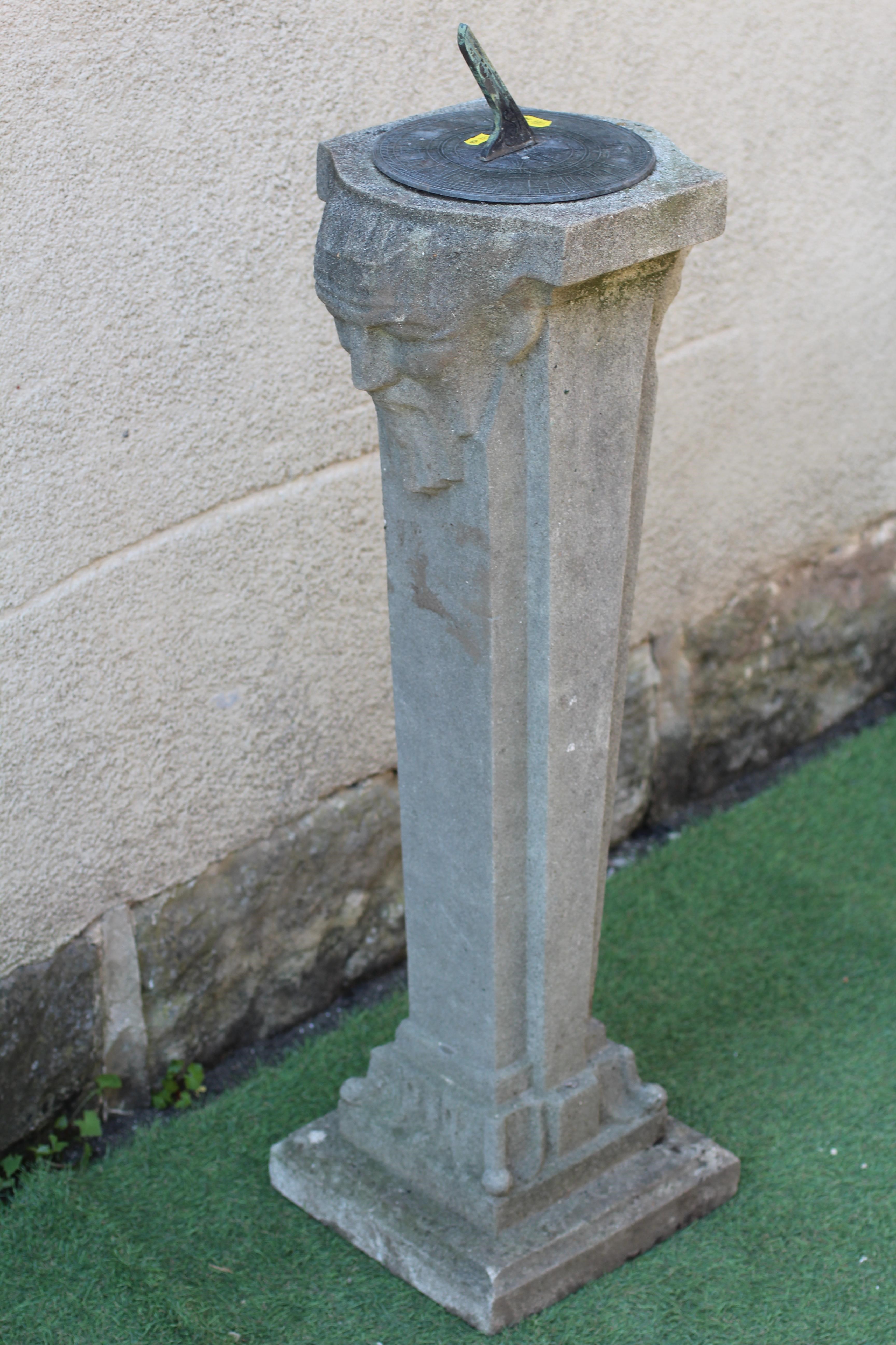 A CAST STONE SUNDIAL, the metal gnomon raised on square tapering column with bearded male mask to Image