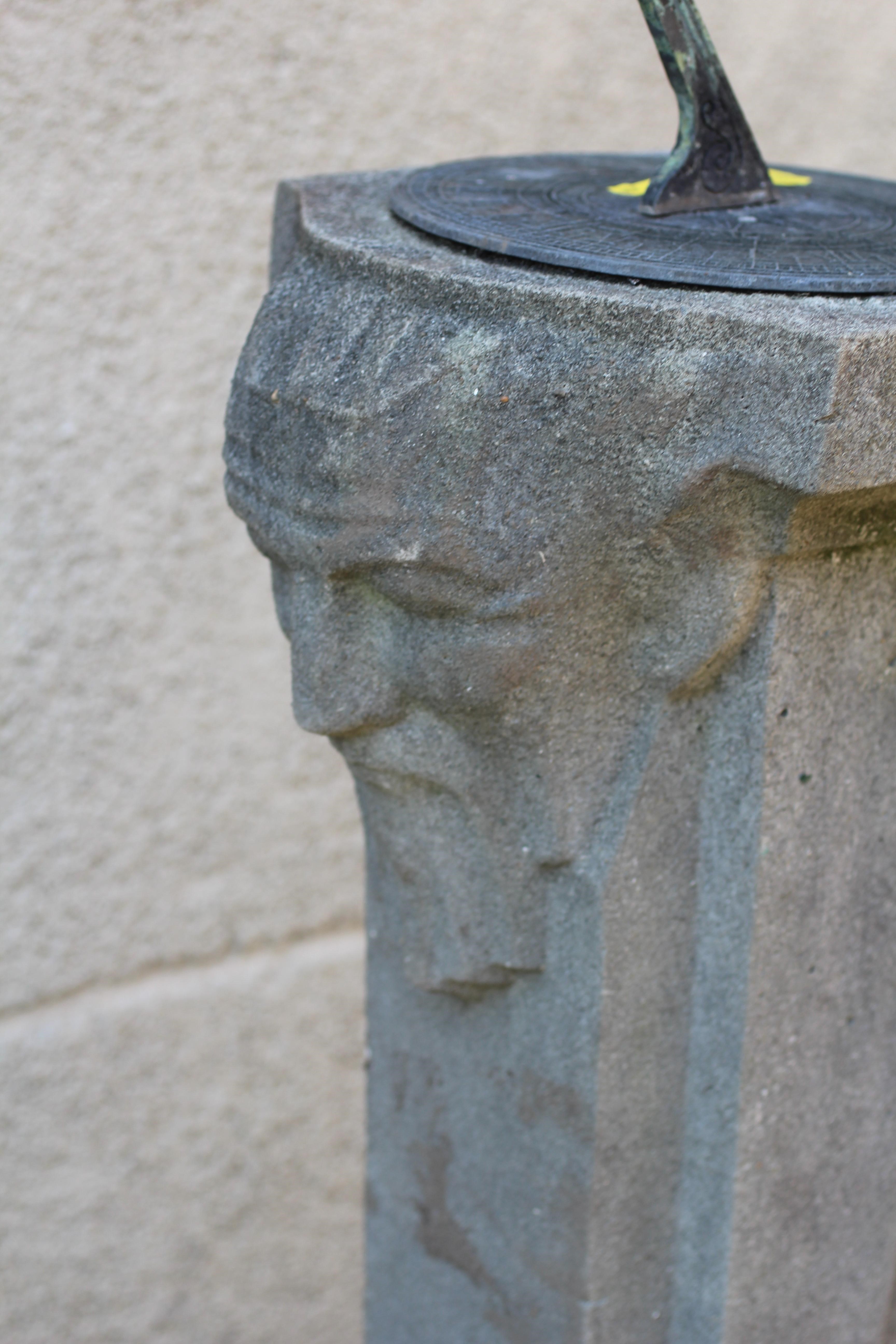 A CAST STONE SUNDIAL, the metal gnomon raised on square tapering column with bearded male mask to Image