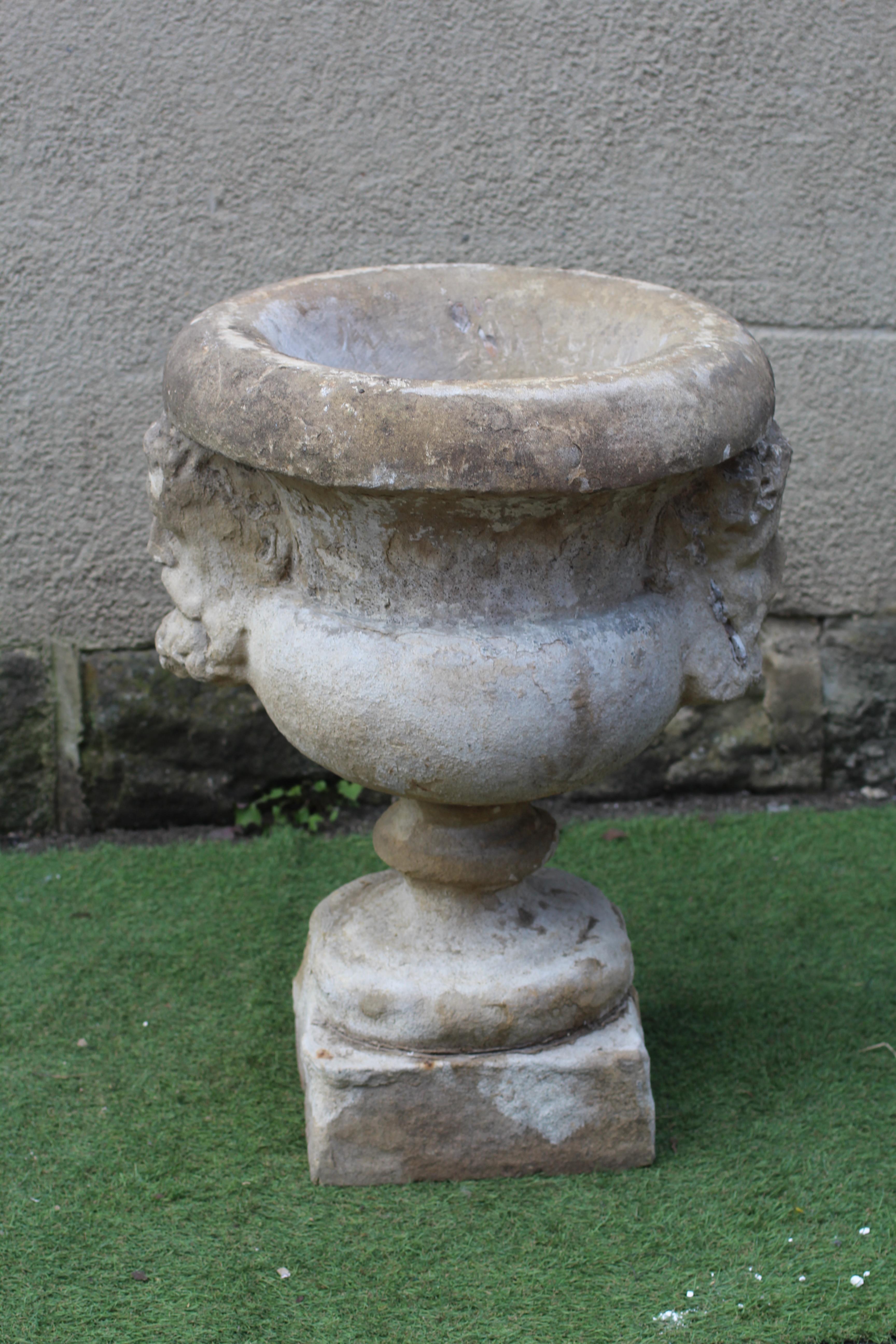 A SANDSTONE CAMPANA URN, 19th century/earlier(?), with fold over rim, the bowl with bearded male Image