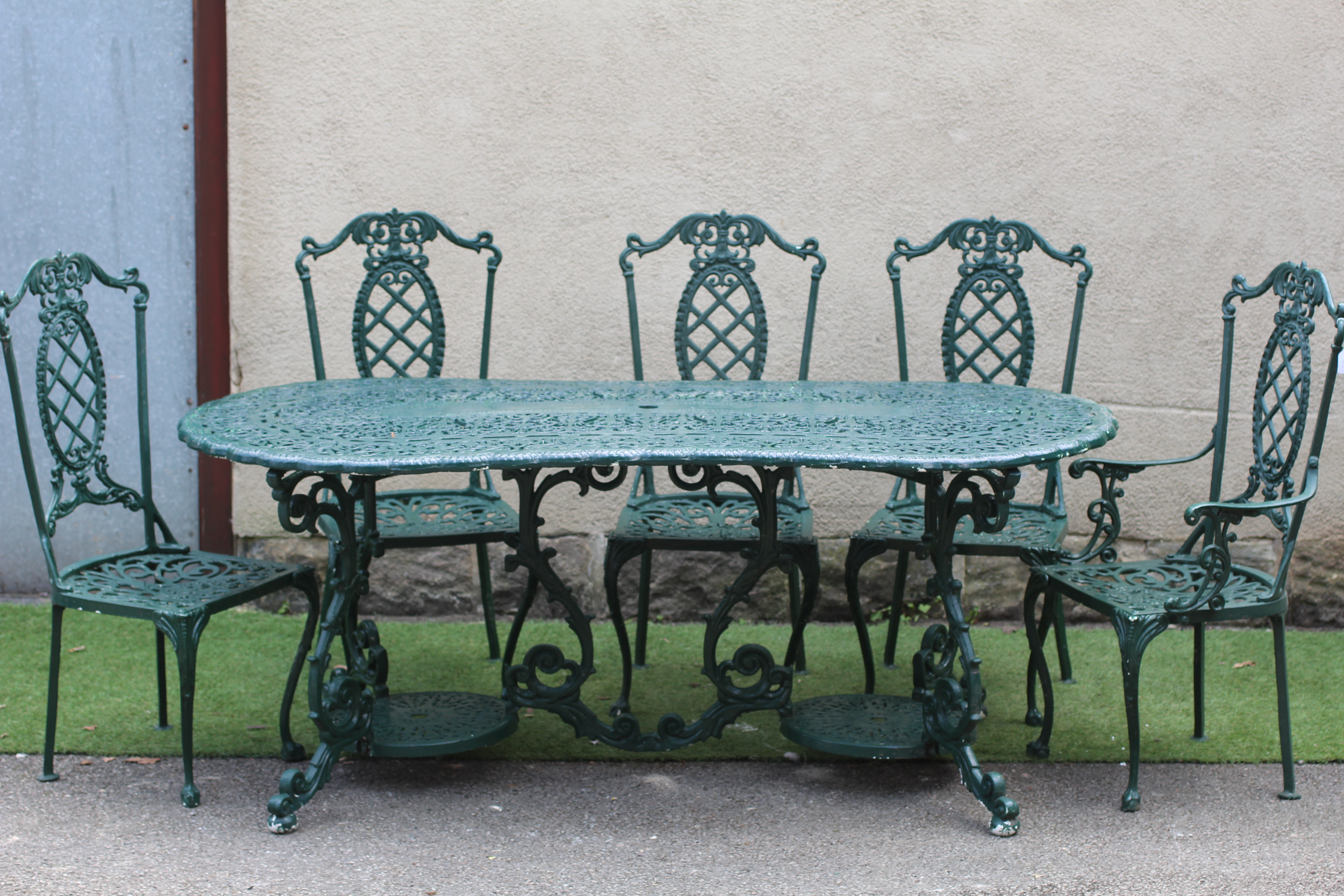 A CAST METAL DINING SUITE Image