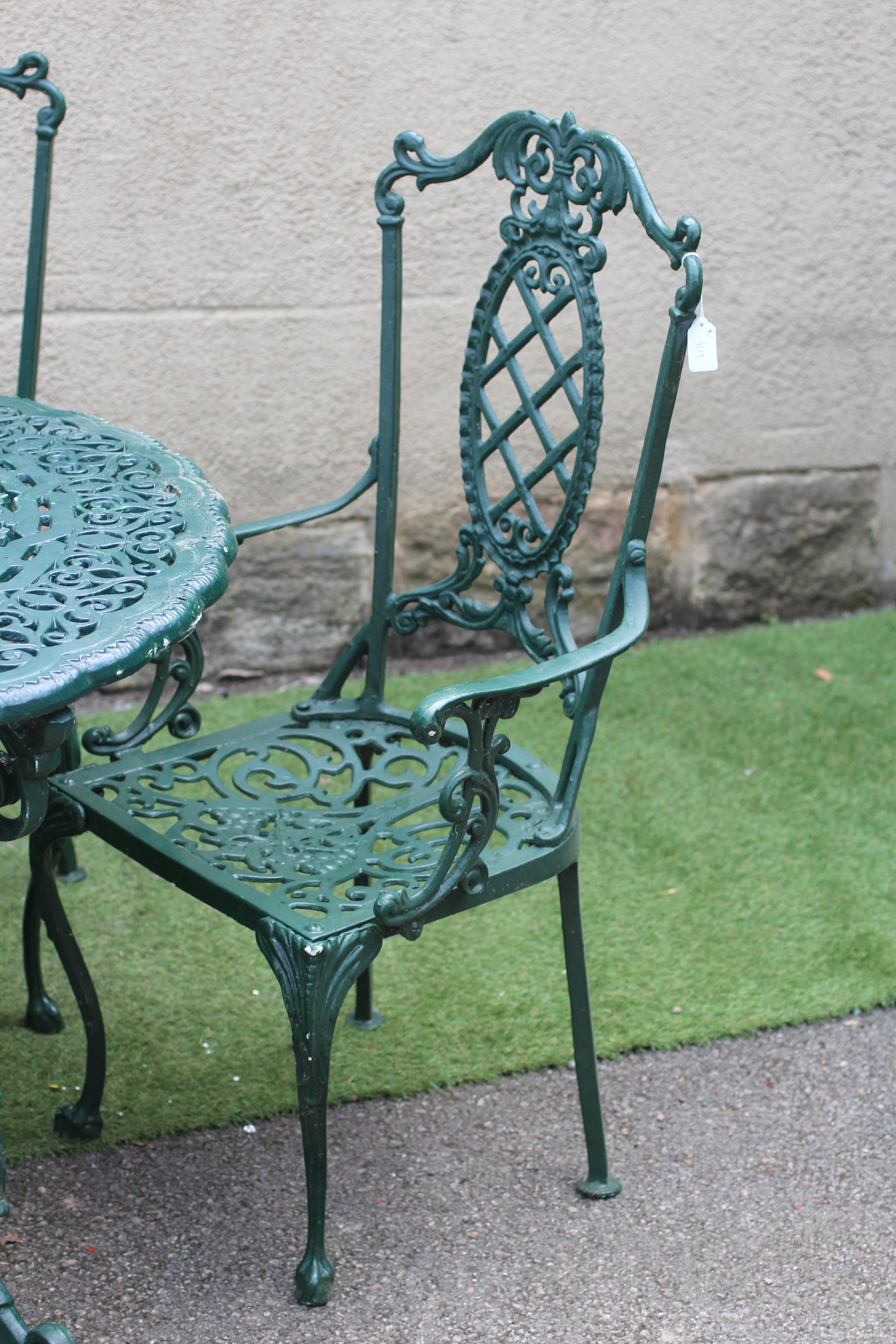 A CAST METAL DINING SUITE Image
