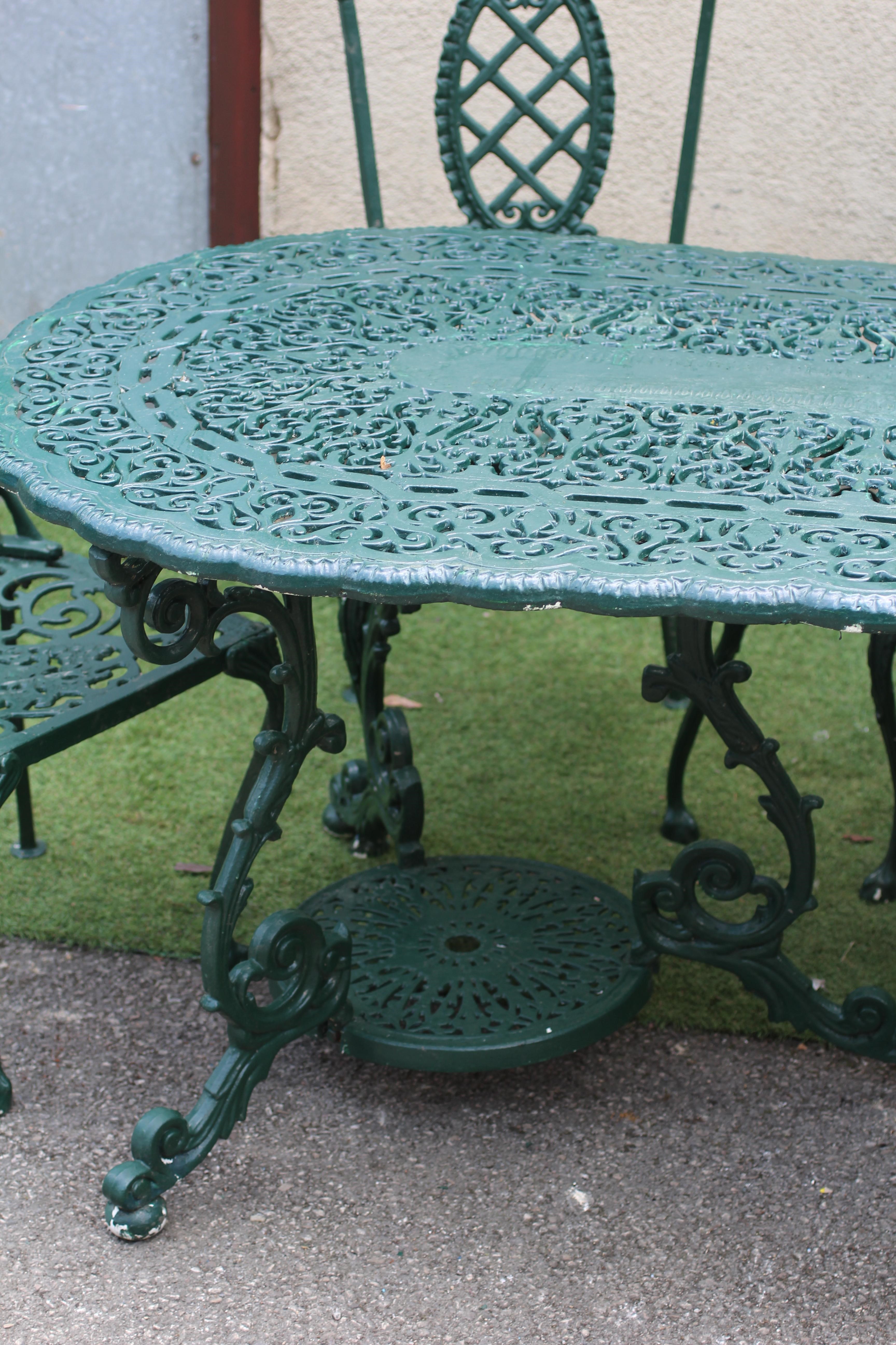 A CAST METAL DINING SUITE Image