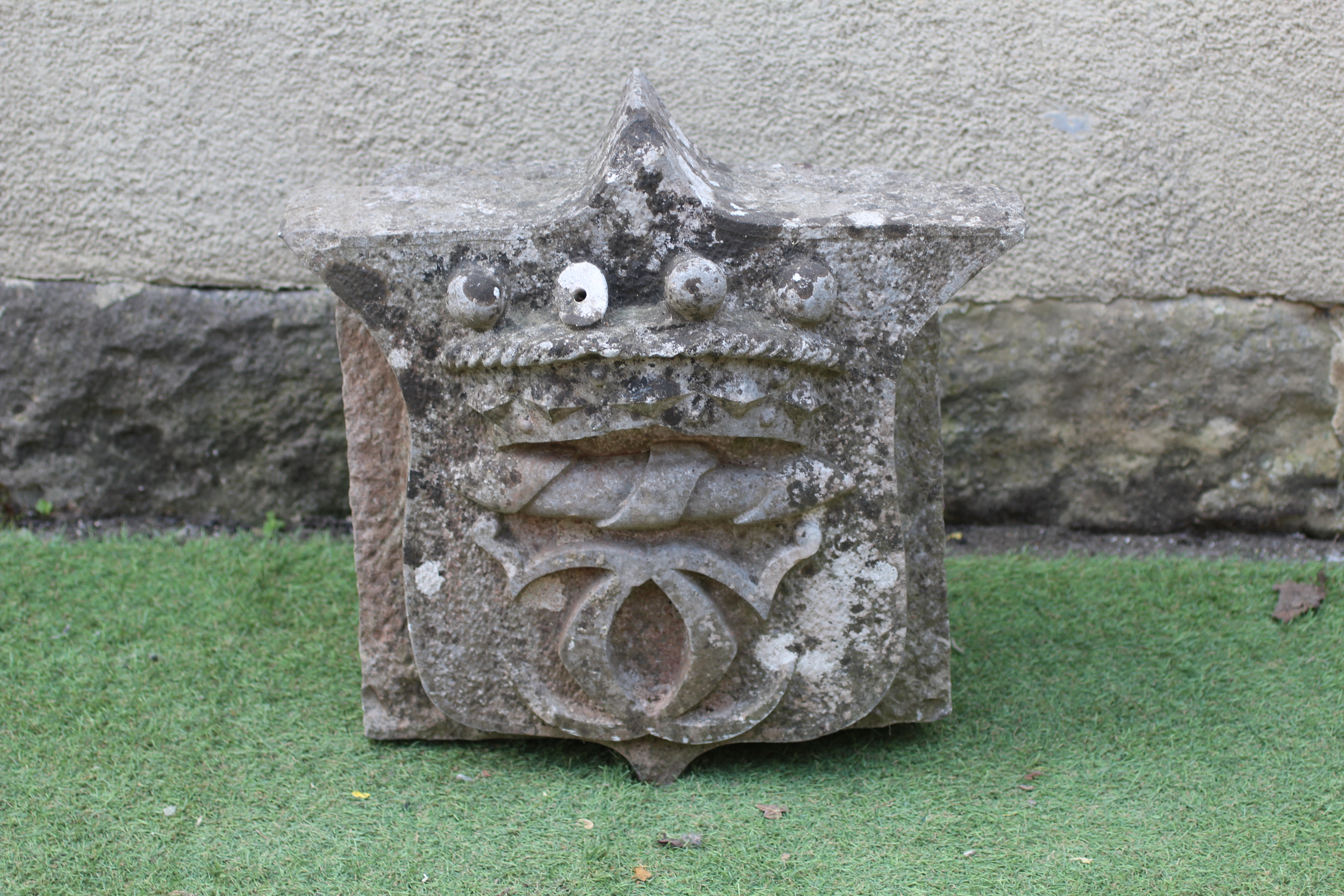 A SANDSTONE ARMORIAL SHIELD, 19th century(?), carved with a crown and monogram, 20 1/2" w x 7 1/2" d Image