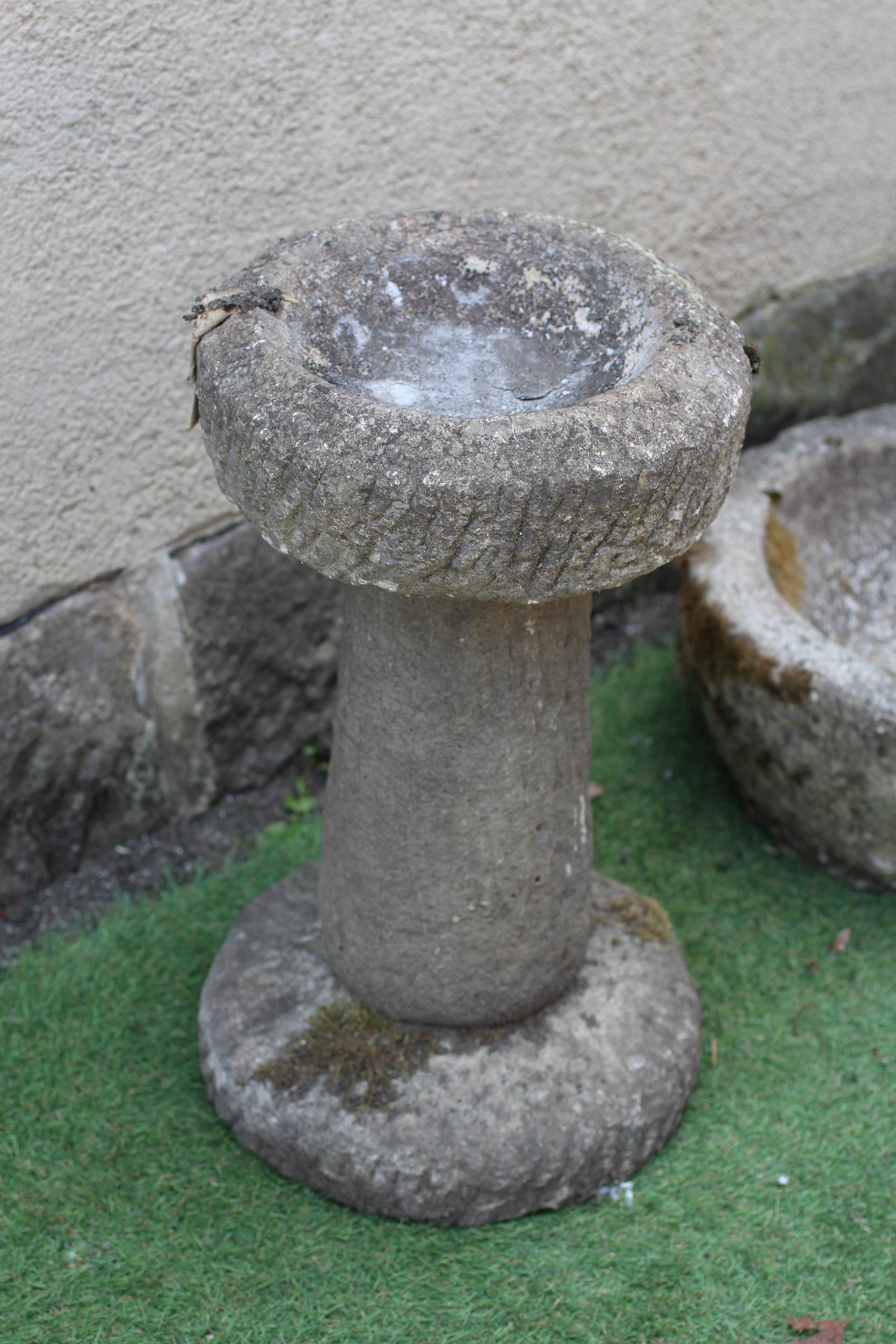 A SANDSTONE CIRCULAR PLANTER with textured tapering bowl, 17" w x 7 1/2" h, together with a similar Image