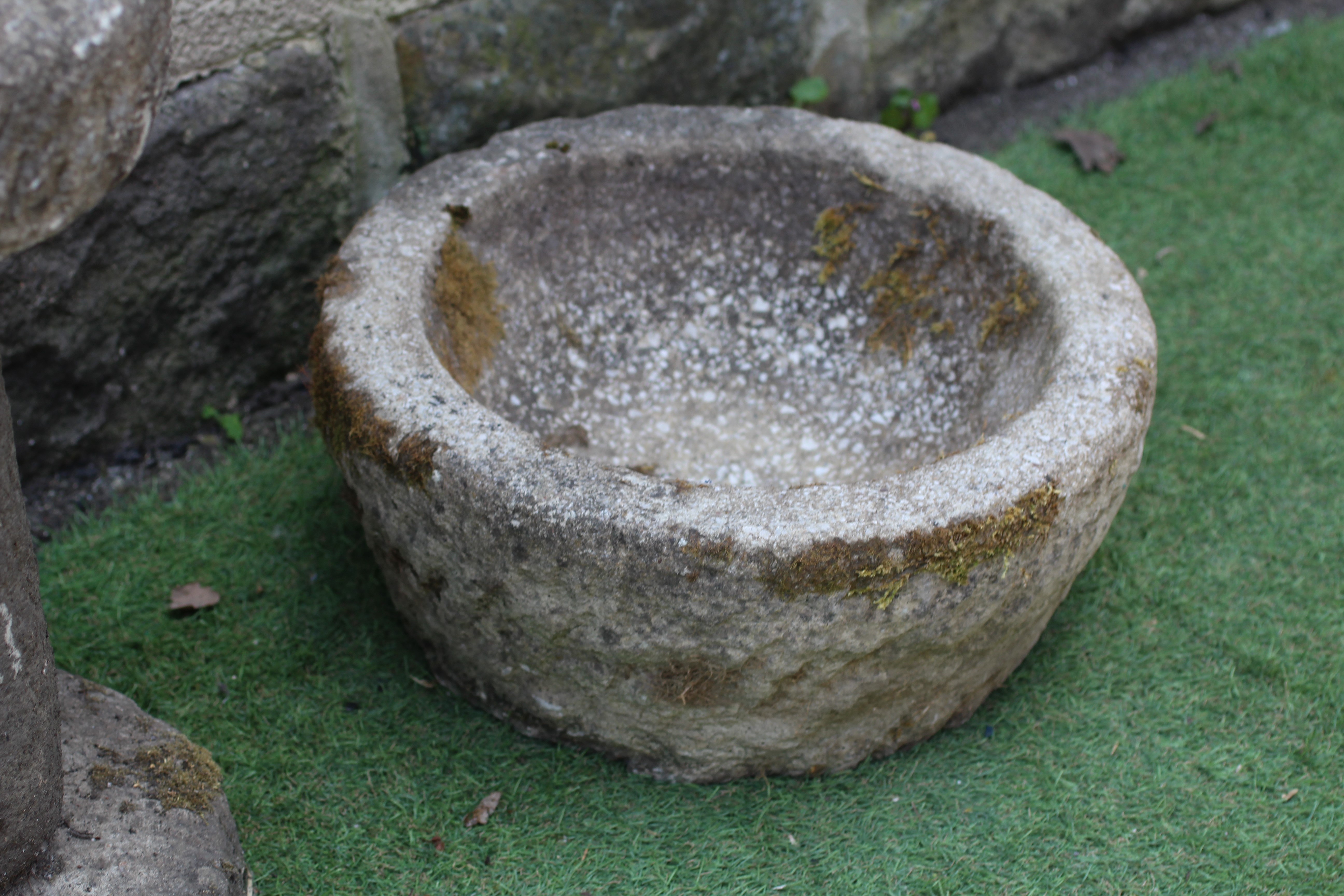 A SANDSTONE CIRCULAR PLANTER with textured tapering bowl, 17" w x 7 1/2" h, together with a similar Image