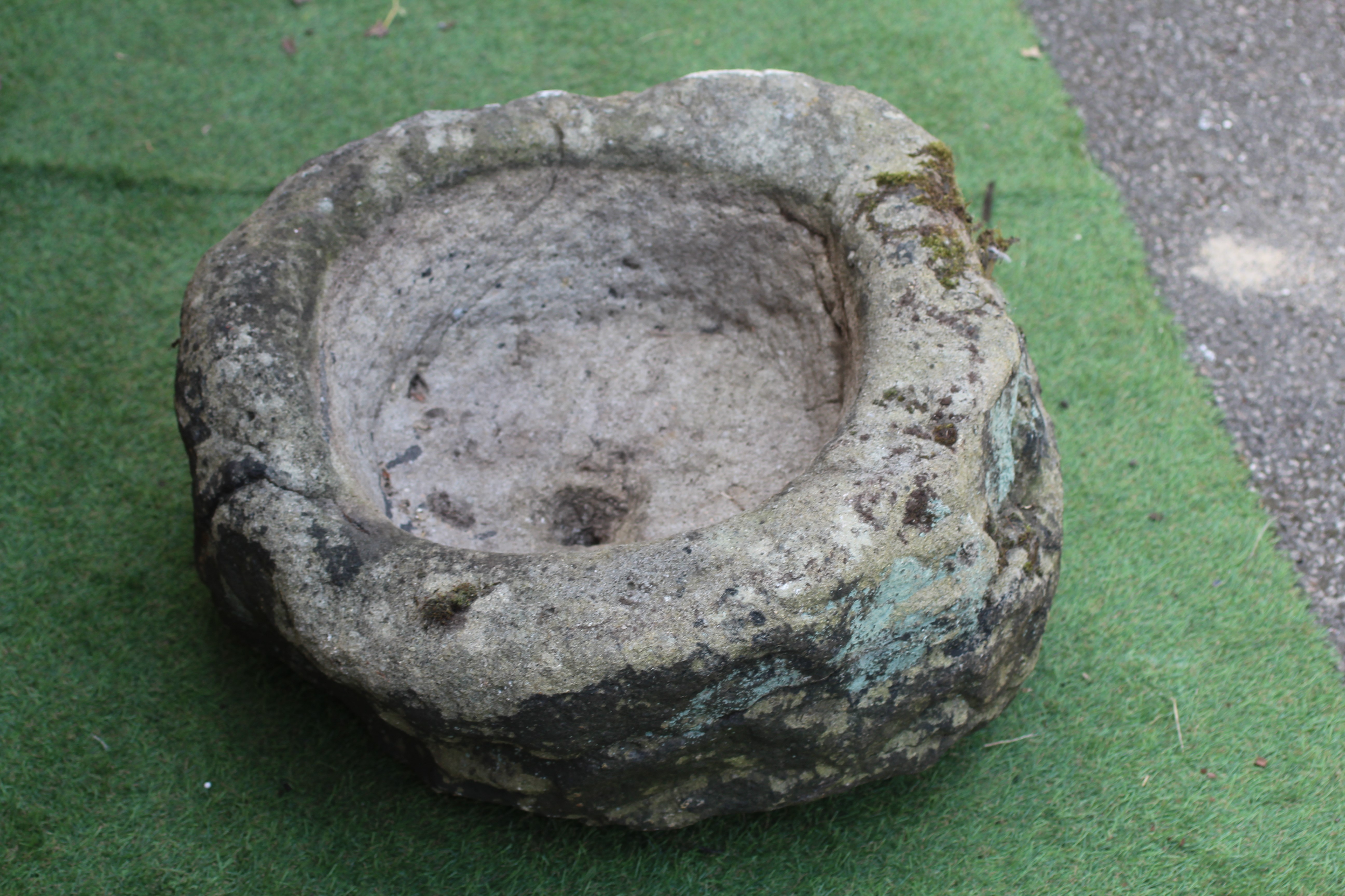 A SANDSTONE TROUGH of rough hewn circular form, 22 1/2" w x 11 1/2" h Image