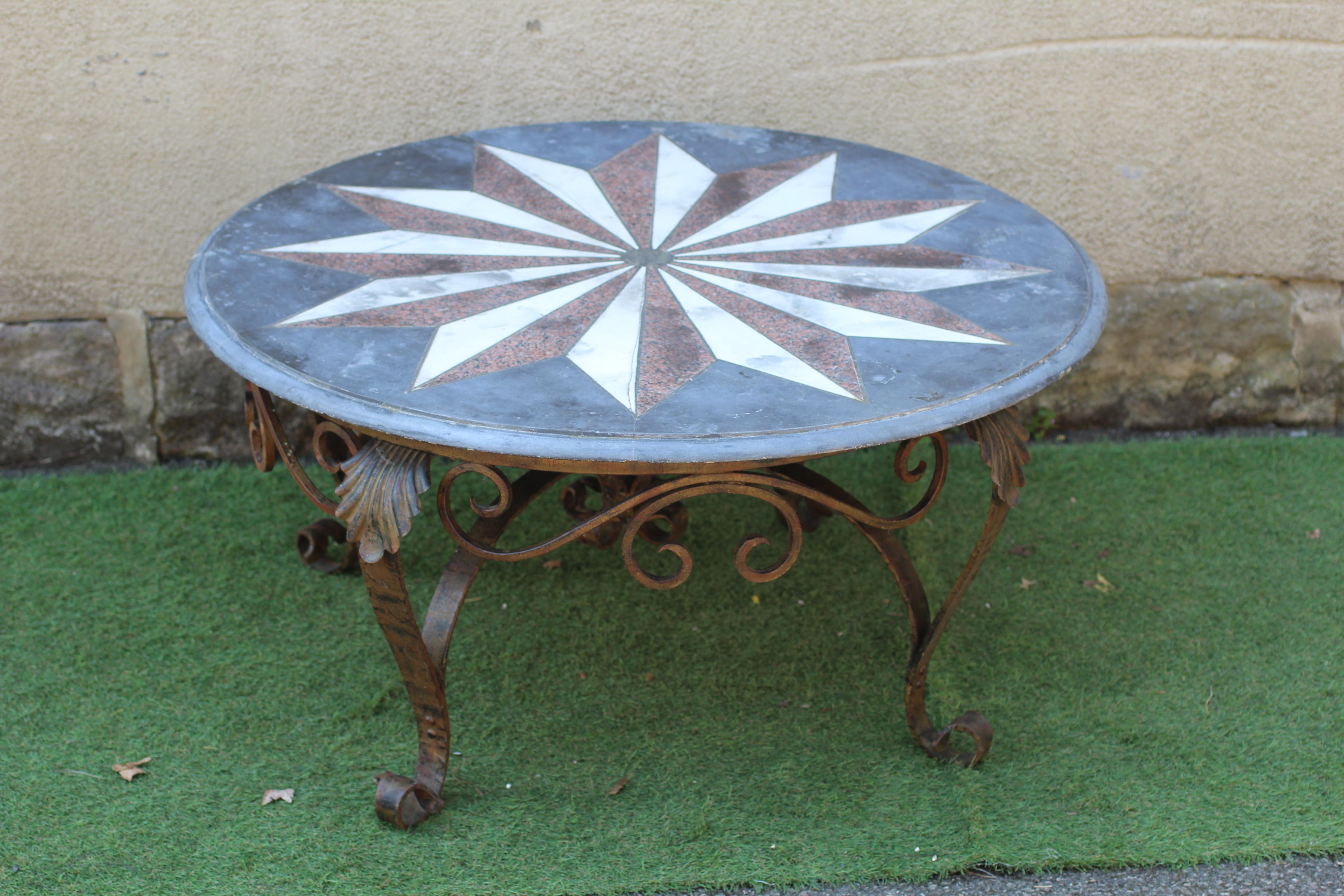 A CIRCULAR SLATE TABLE TOP, 19th century, with moulded edge and inset with a star, Image