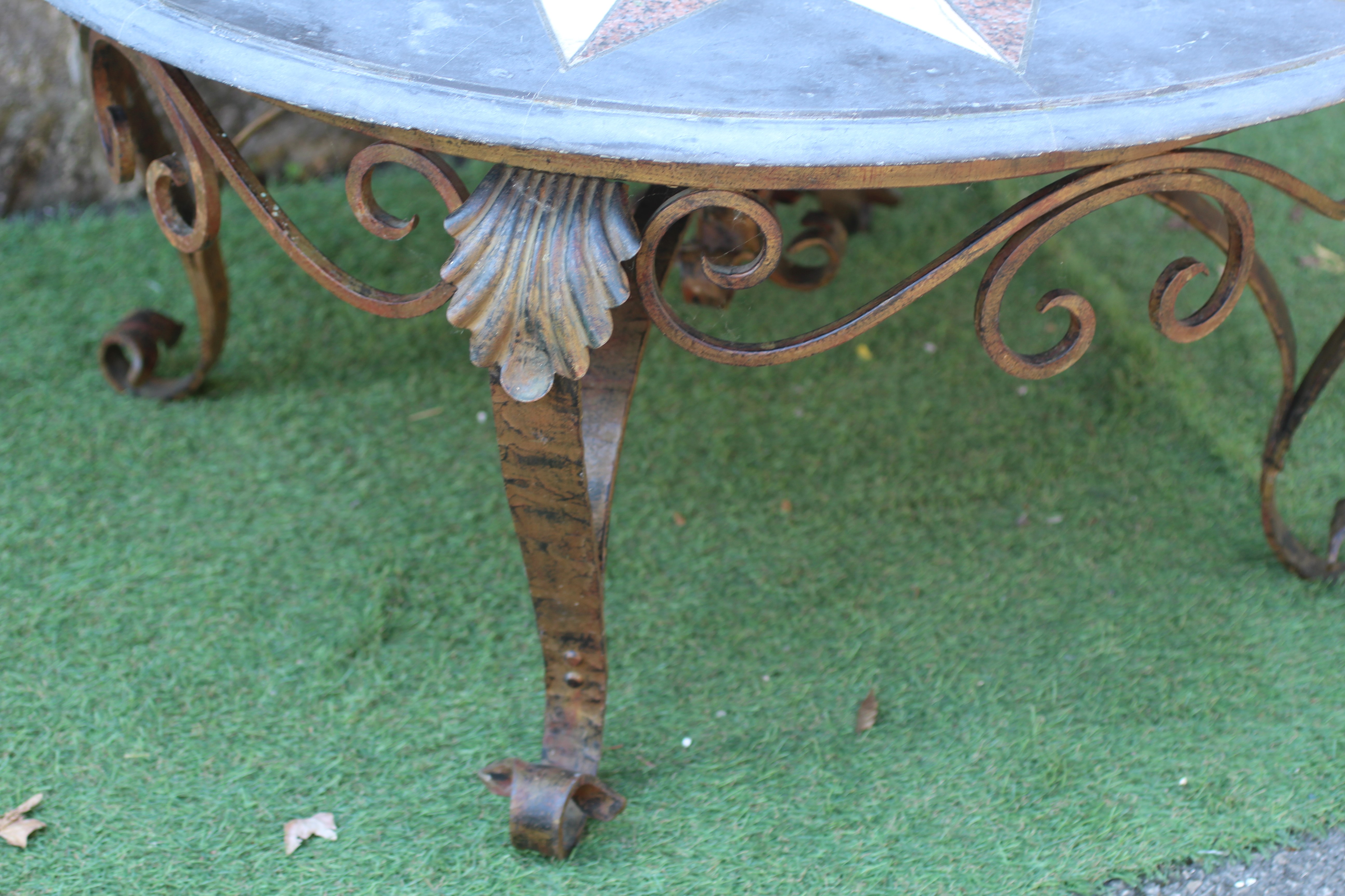 A CIRCULAR SLATE TABLE TOP, 19th century, with moulded edge and inset with a star, Image