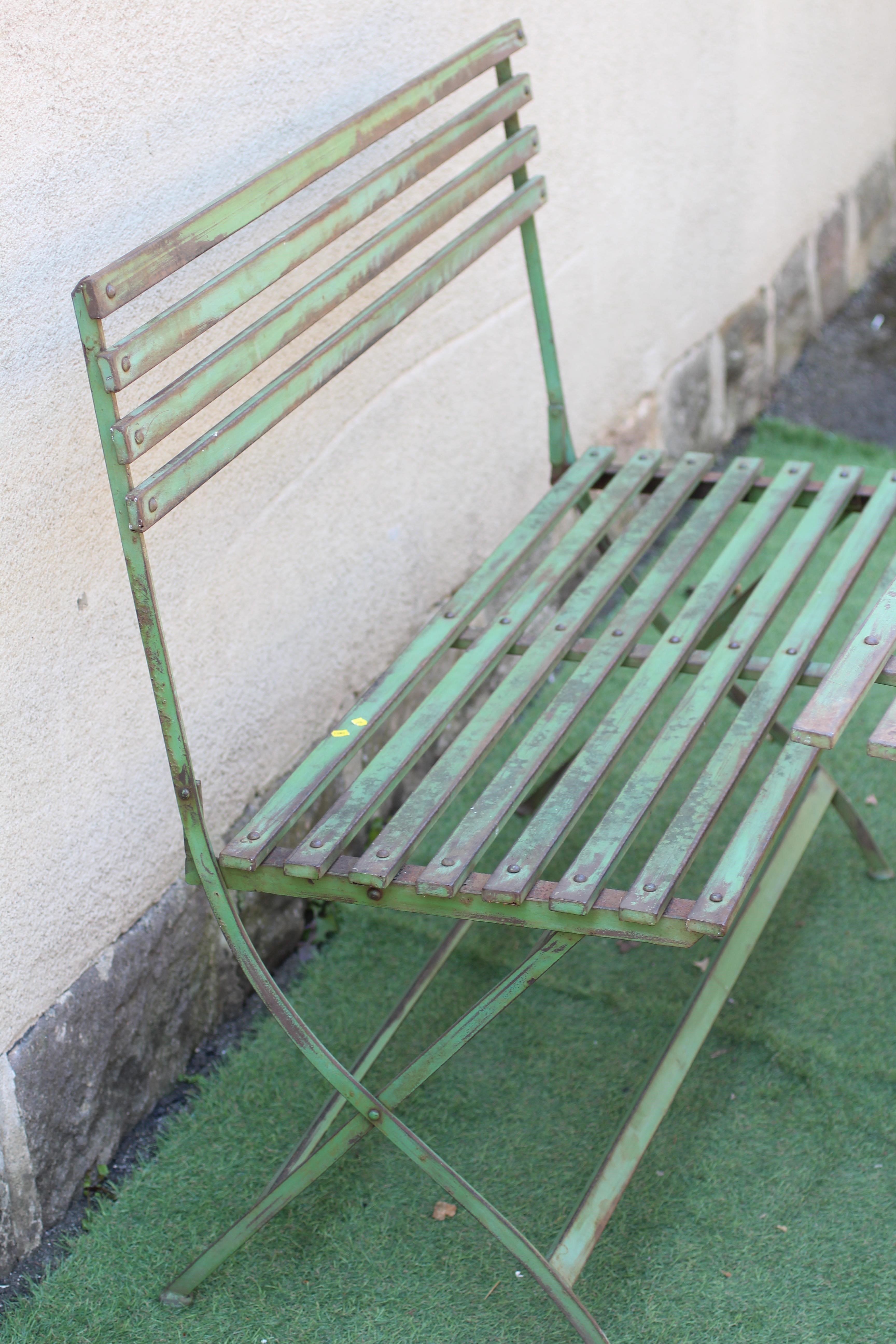A GREEN PAINTED ALLOY PART DINING SUITE of slatted folding form Image