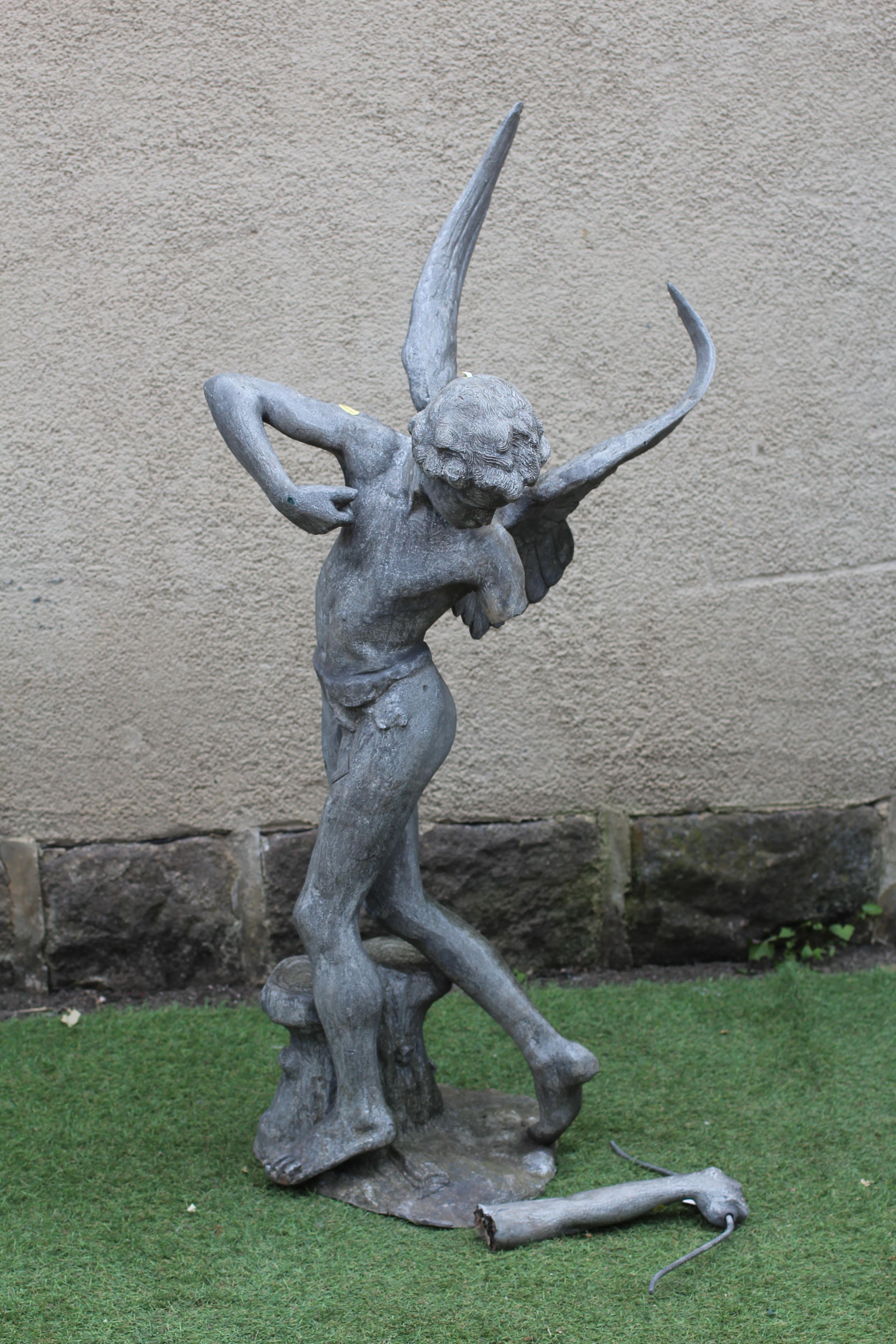 A LEAD FIGURE OF CUPID, modern, modelled standing and firing his arrow, on domed base, 13 1/2" w x Image