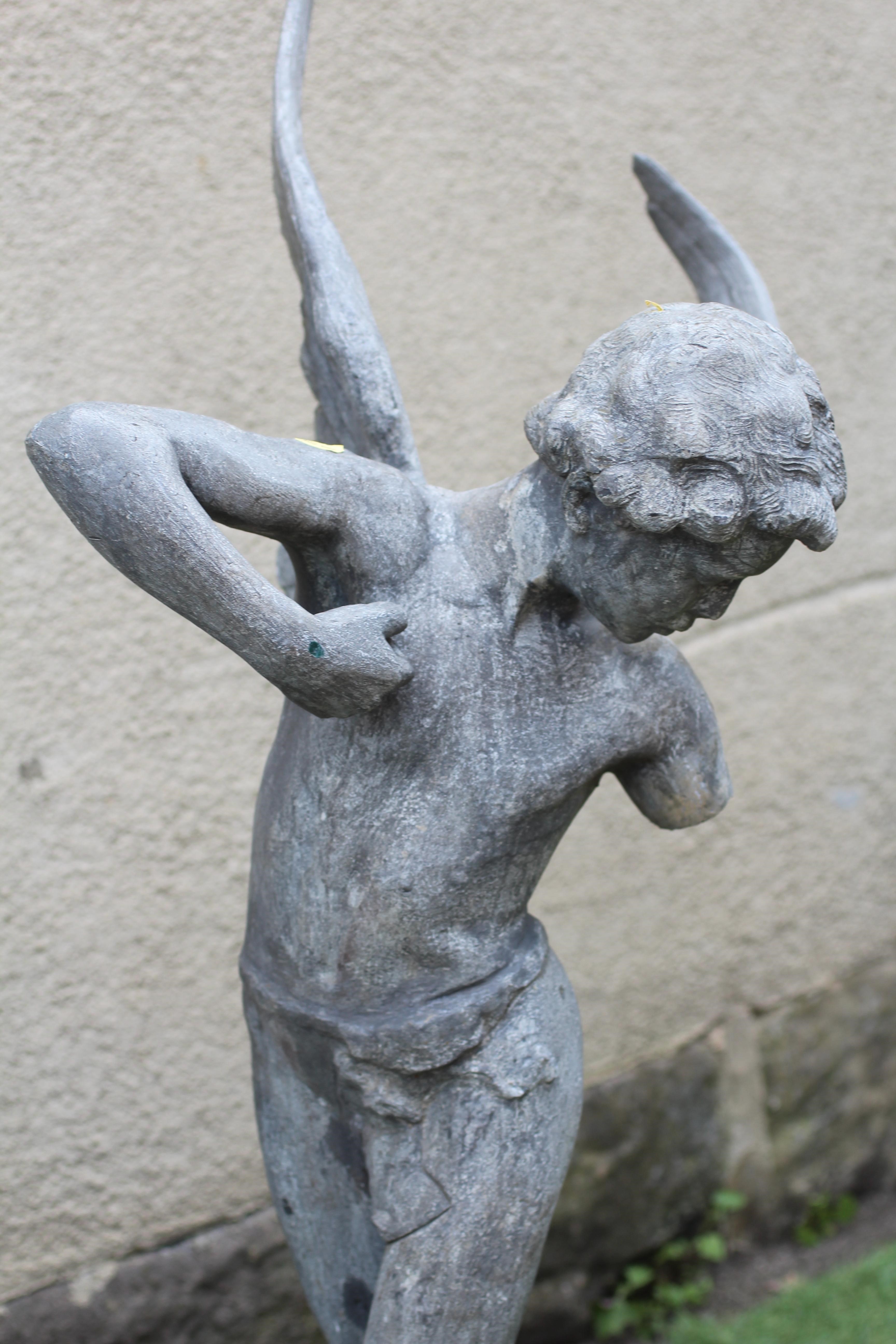 A LEAD FIGURE OF CUPID, modern, modelled standing and firing his arrow, on domed base, 13 1/2" w x Image