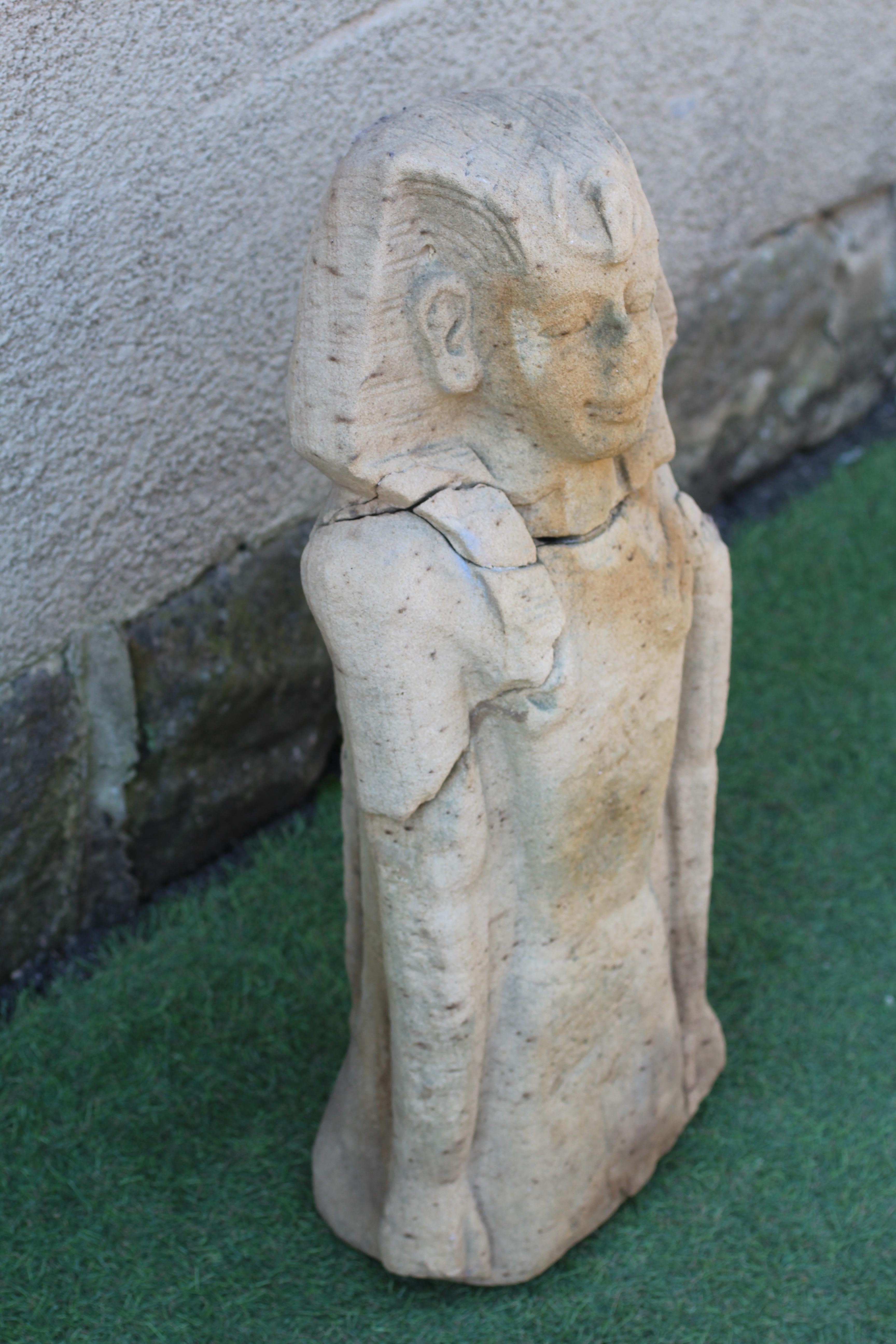 AN EGYPTIAN CARVED SANDSTONE FIGURE OF A BOY, half length and possibly antique, and with carved Image