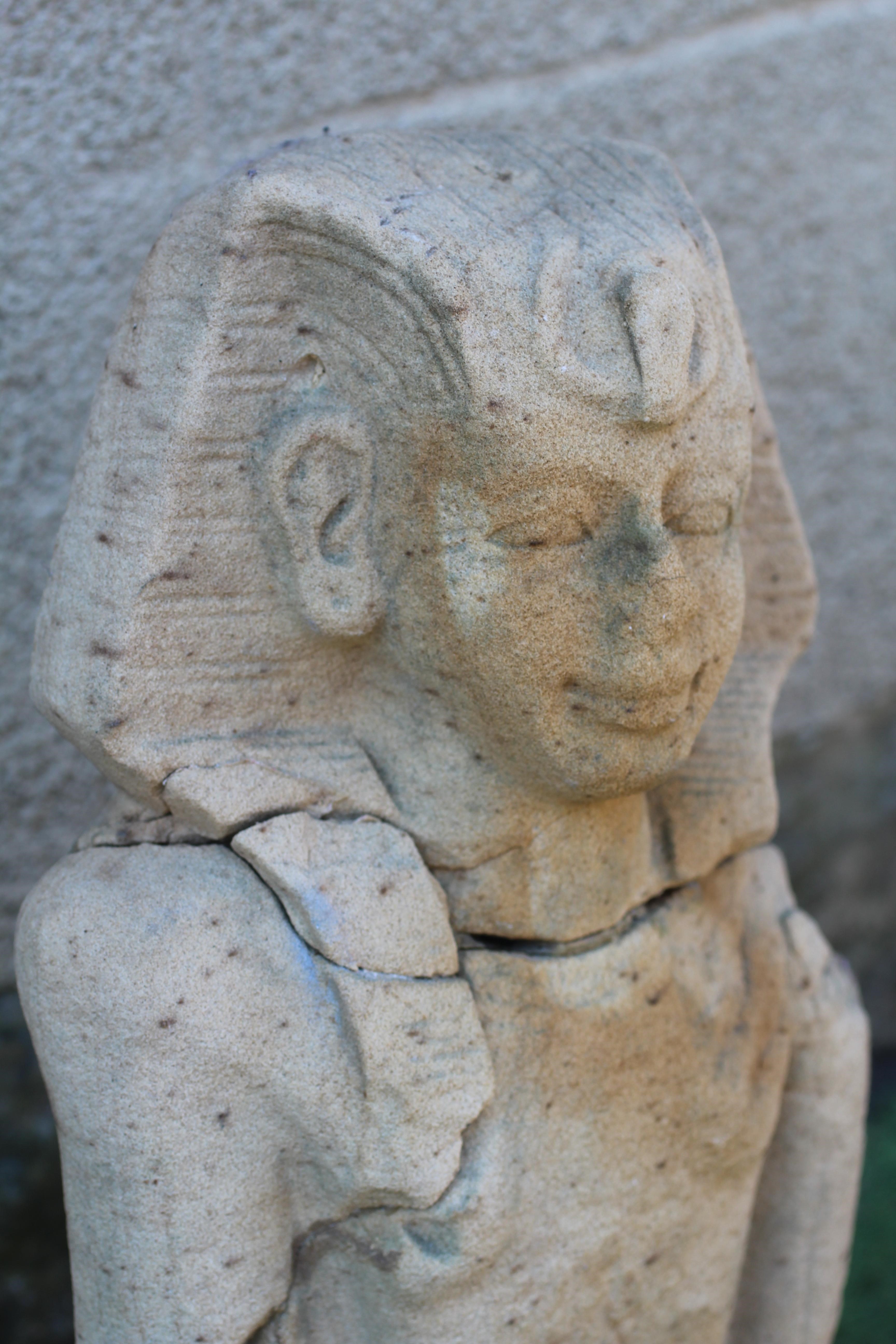 AN EGYPTIAN CARVED SANDSTONE FIGURE OF A BOY, half length and possibly antique, and with carved Image