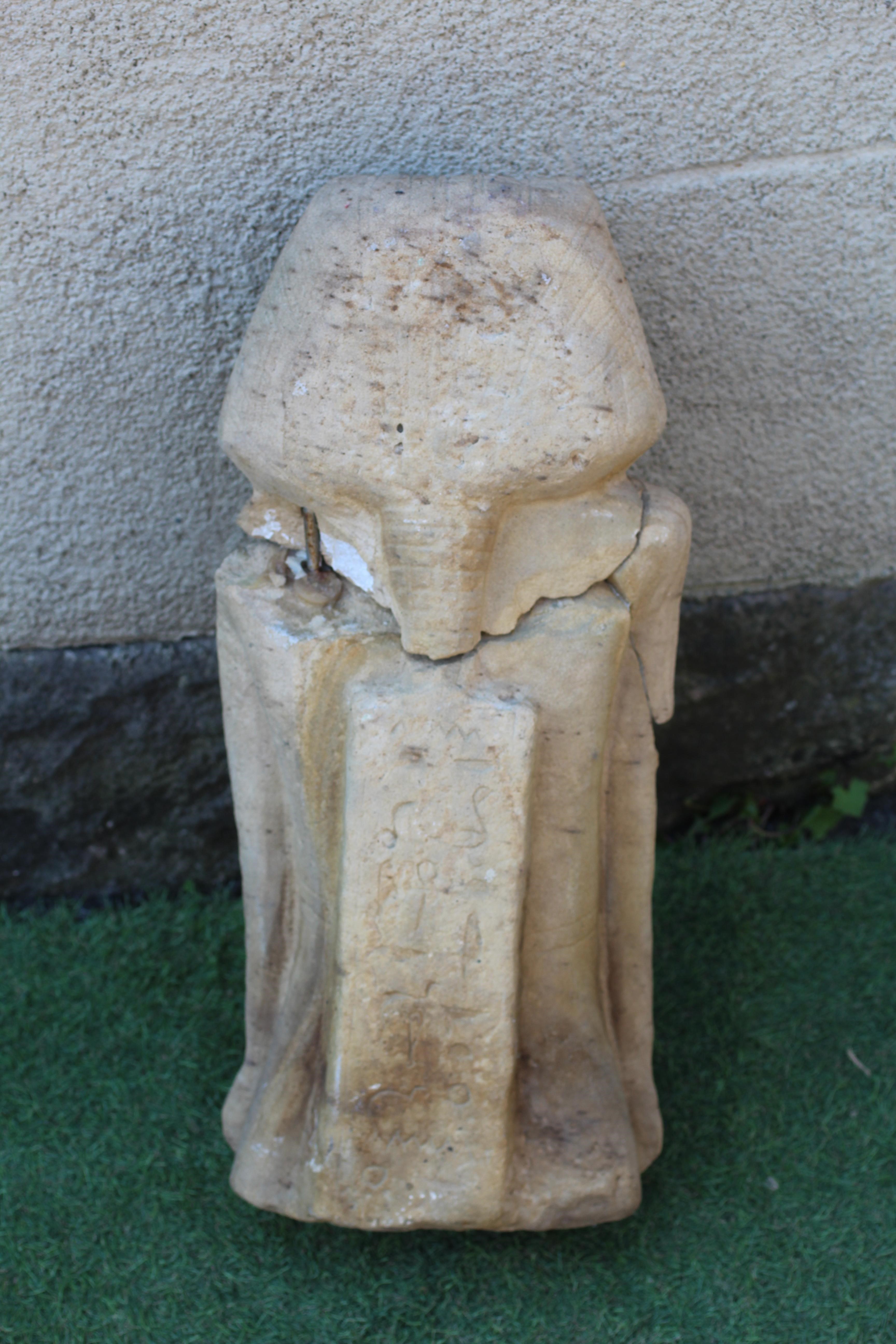 AN EGYPTIAN CARVED SANDSTONE FIGURE OF A BOY, half length and possibly antique, and with carved Image