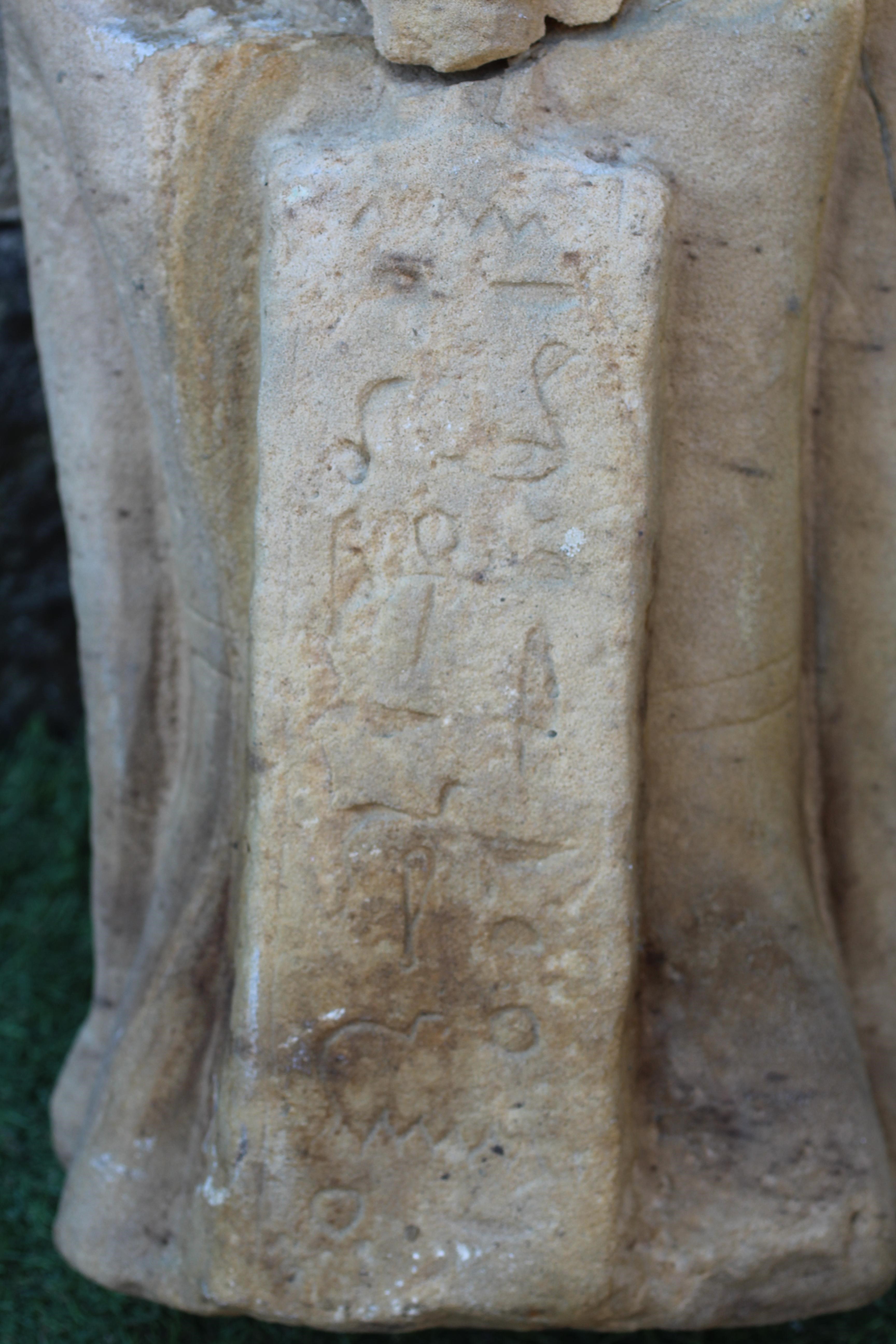 AN EGYPTIAN CARVED SANDSTONE FIGURE OF A BOY, half length and possibly antique, and with carved Image