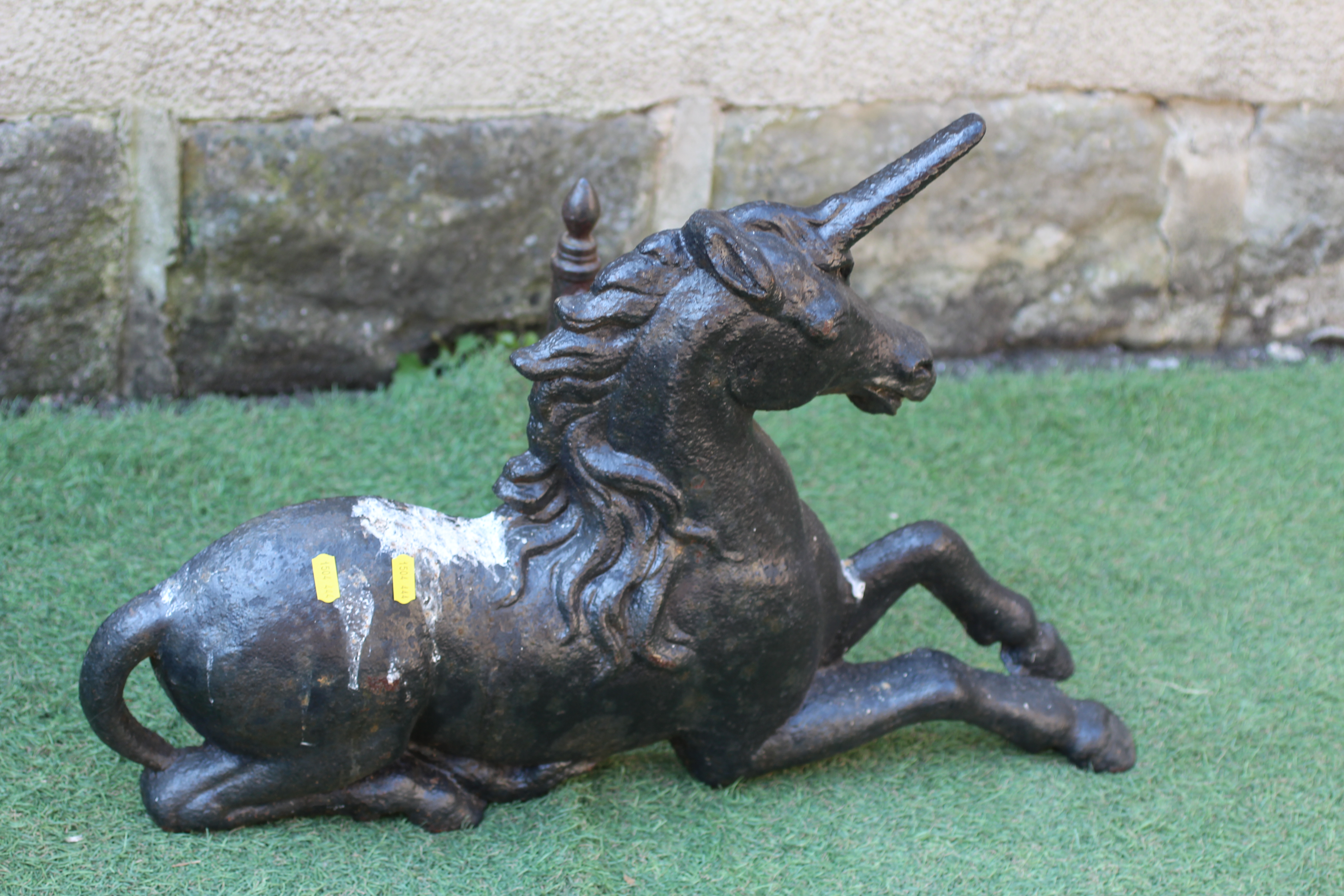 A VICTORIAN CAST IRON HERALDIC RECUMBENT UNICORN FOOT SCRAPER possibly by John Crowley & Co., Image