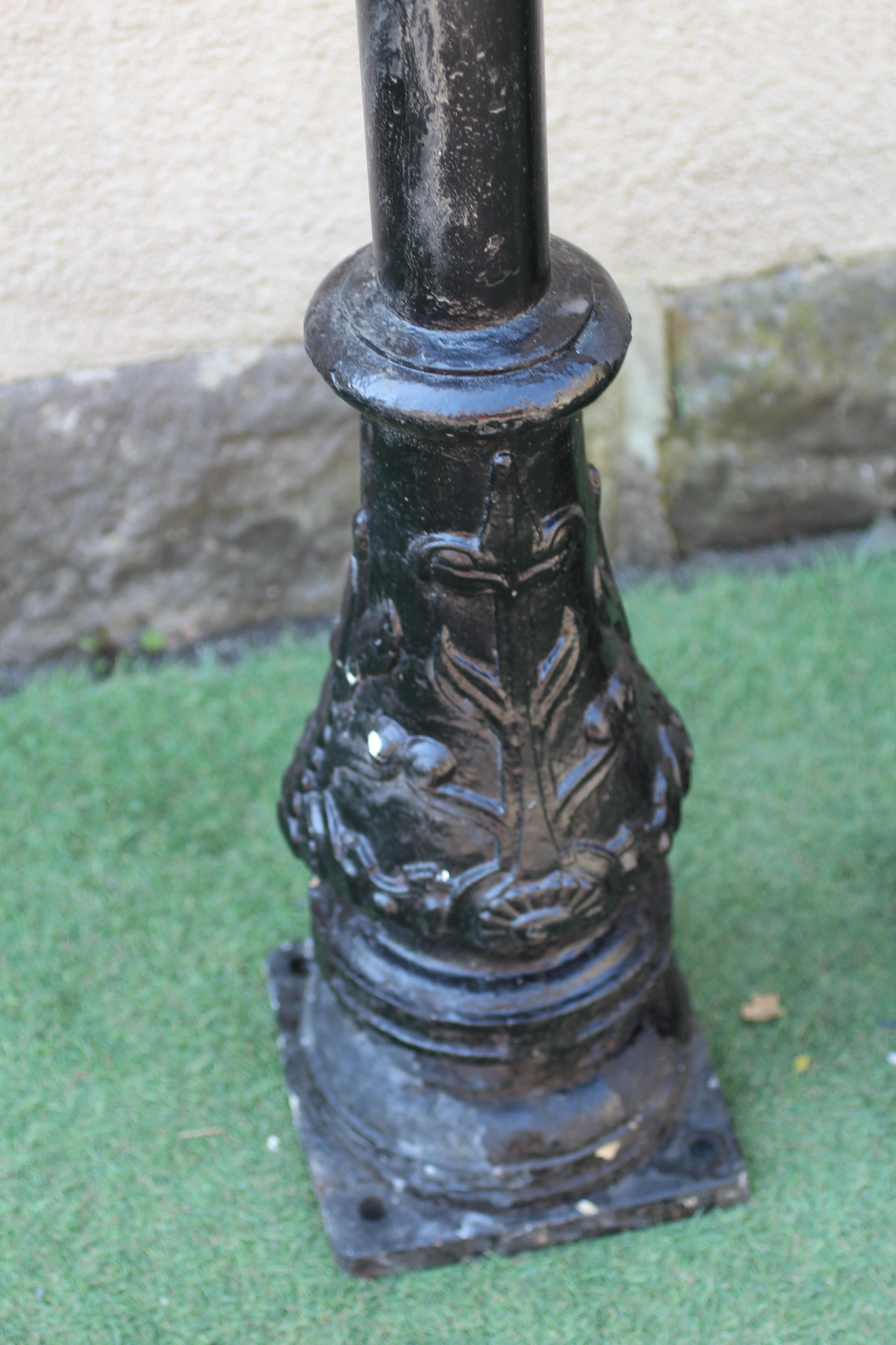 A PAIR OF VICTORIAN STYLE CAST ALLOY LAMP POSTS, lacking hoods, the tubular stem with leaf and Image