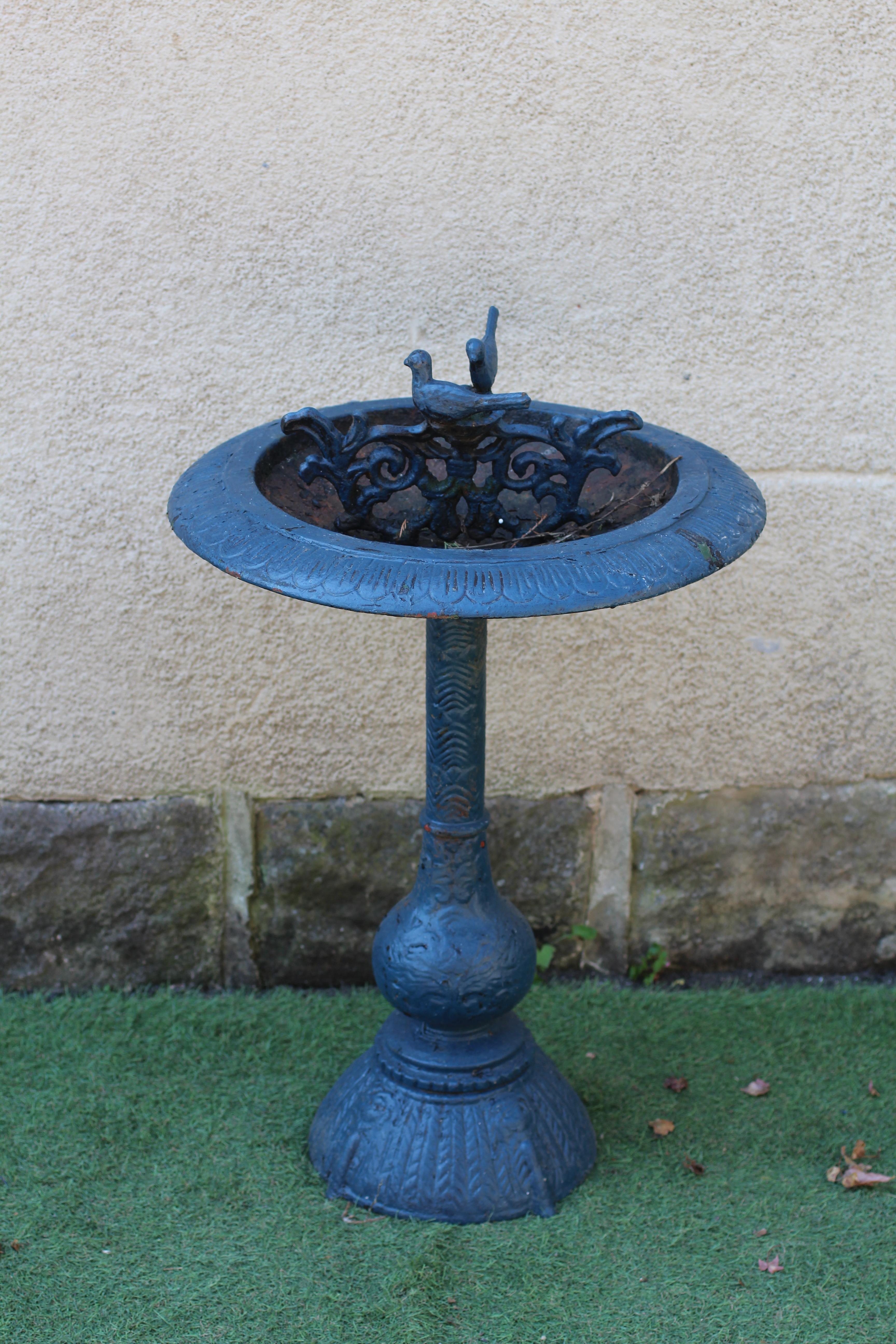 A CAST IRON BIRD BATH, the shallow bowl with egg and dart moulded rim and pierced scroll centre Image