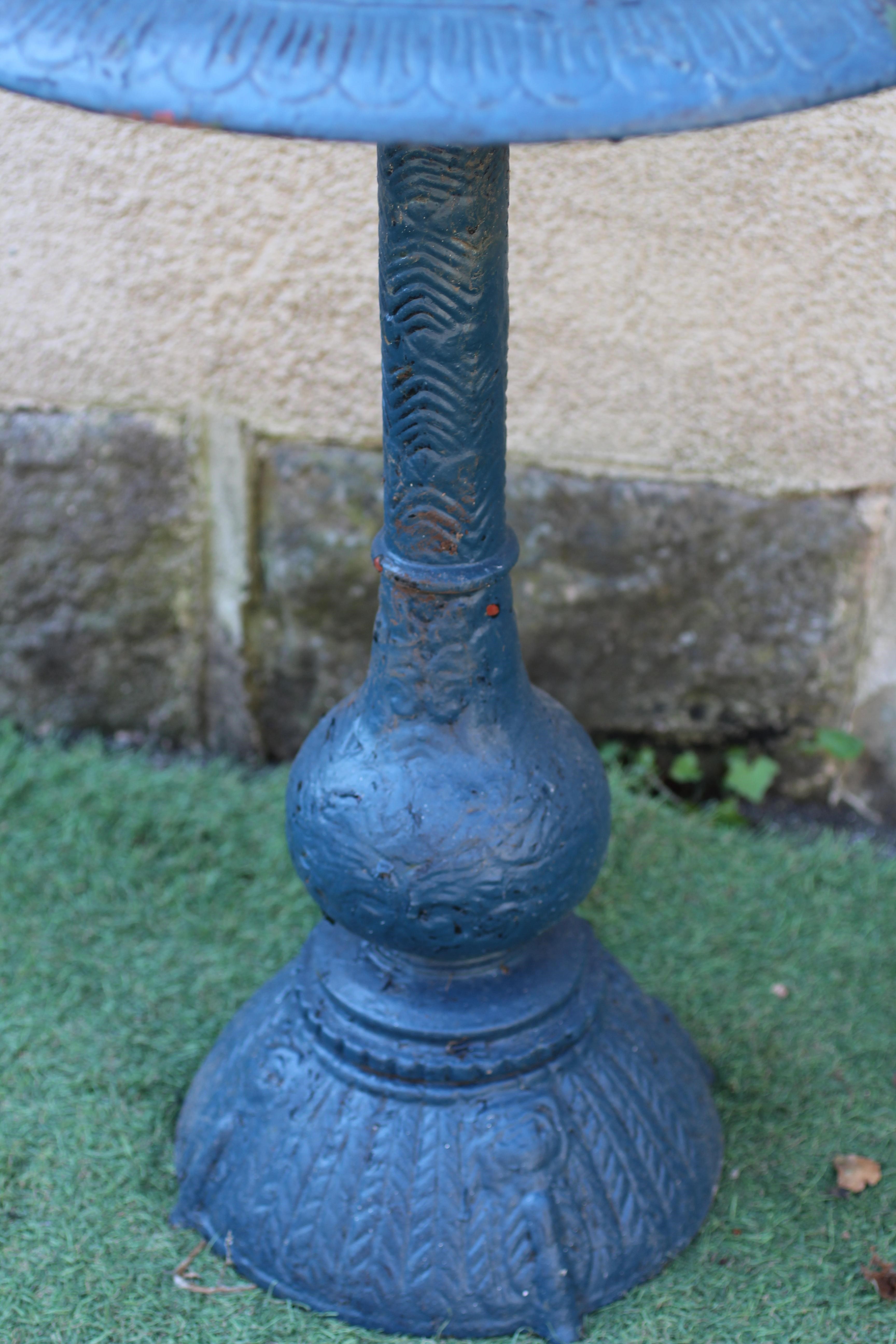A CAST IRON BIRD BATH, the shallow bowl with egg and dart moulded rim and pierced scroll centre Image