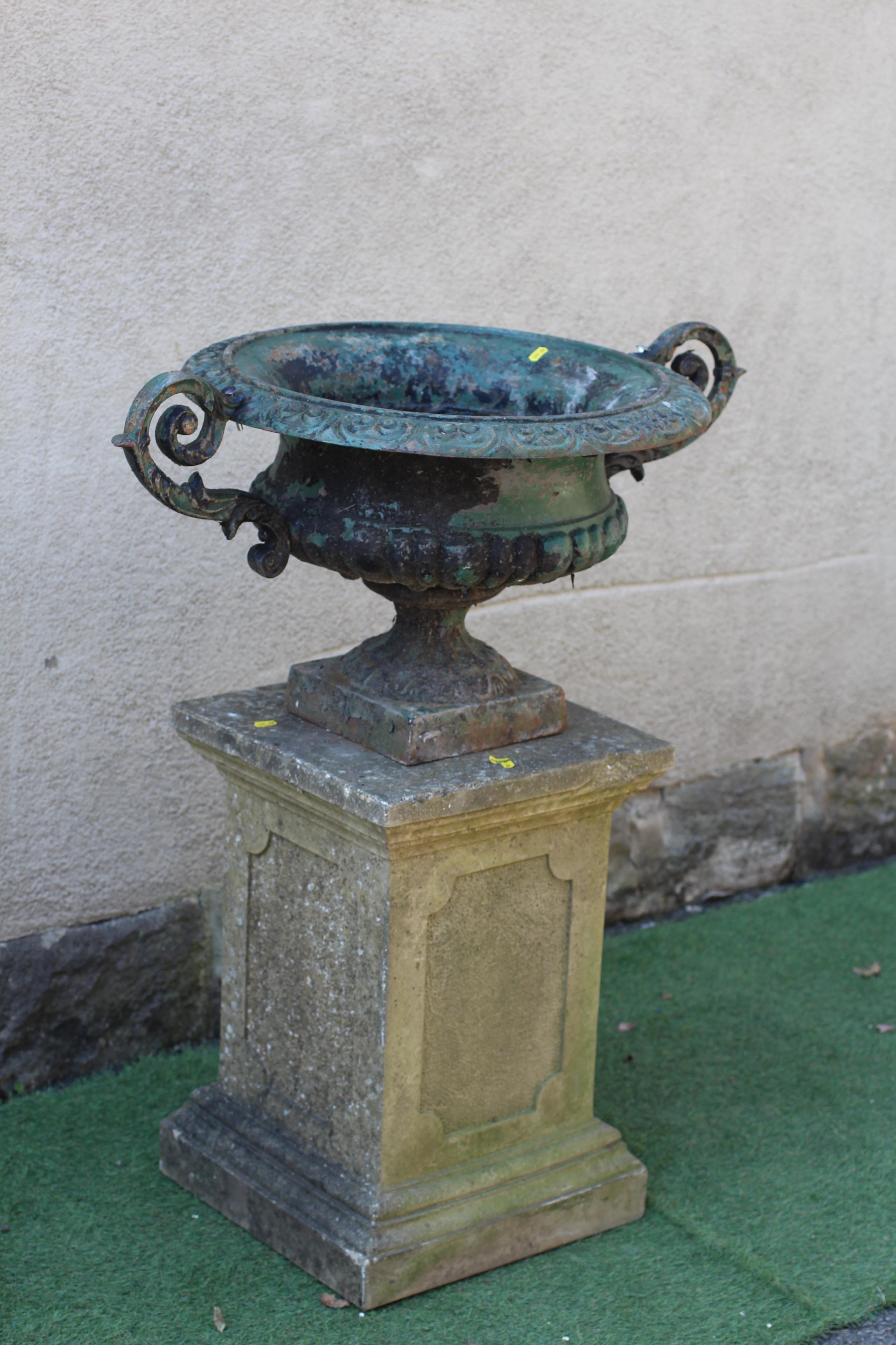 A LARGE VICTORIAN CAST IRON URN of half fluted campana form with scroll moulded rim and pierced Image