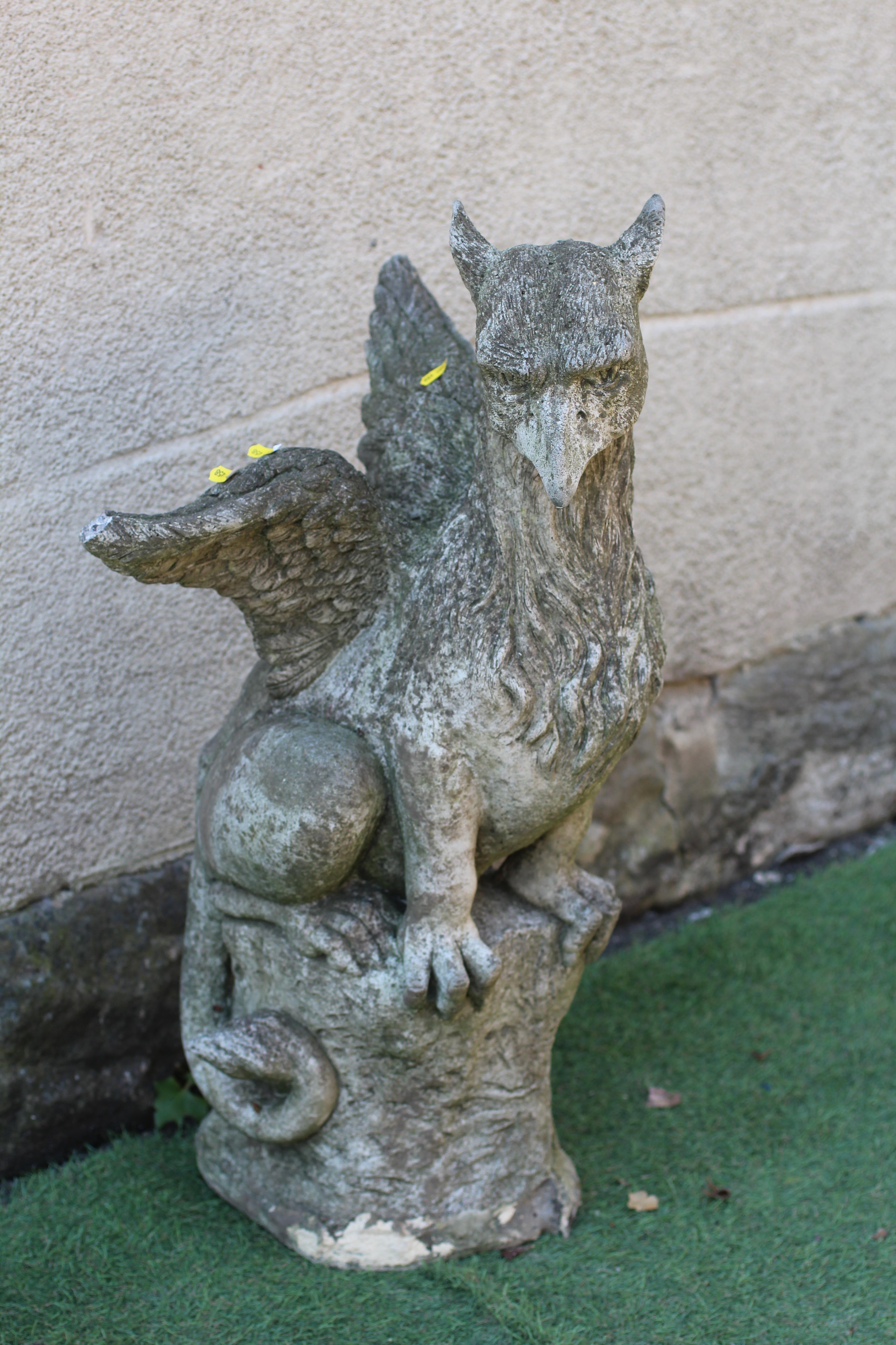 A CAST STONE GRIFFIN modelled with outstretched wings, on domed base, 16" w x 29 1/2" h Image