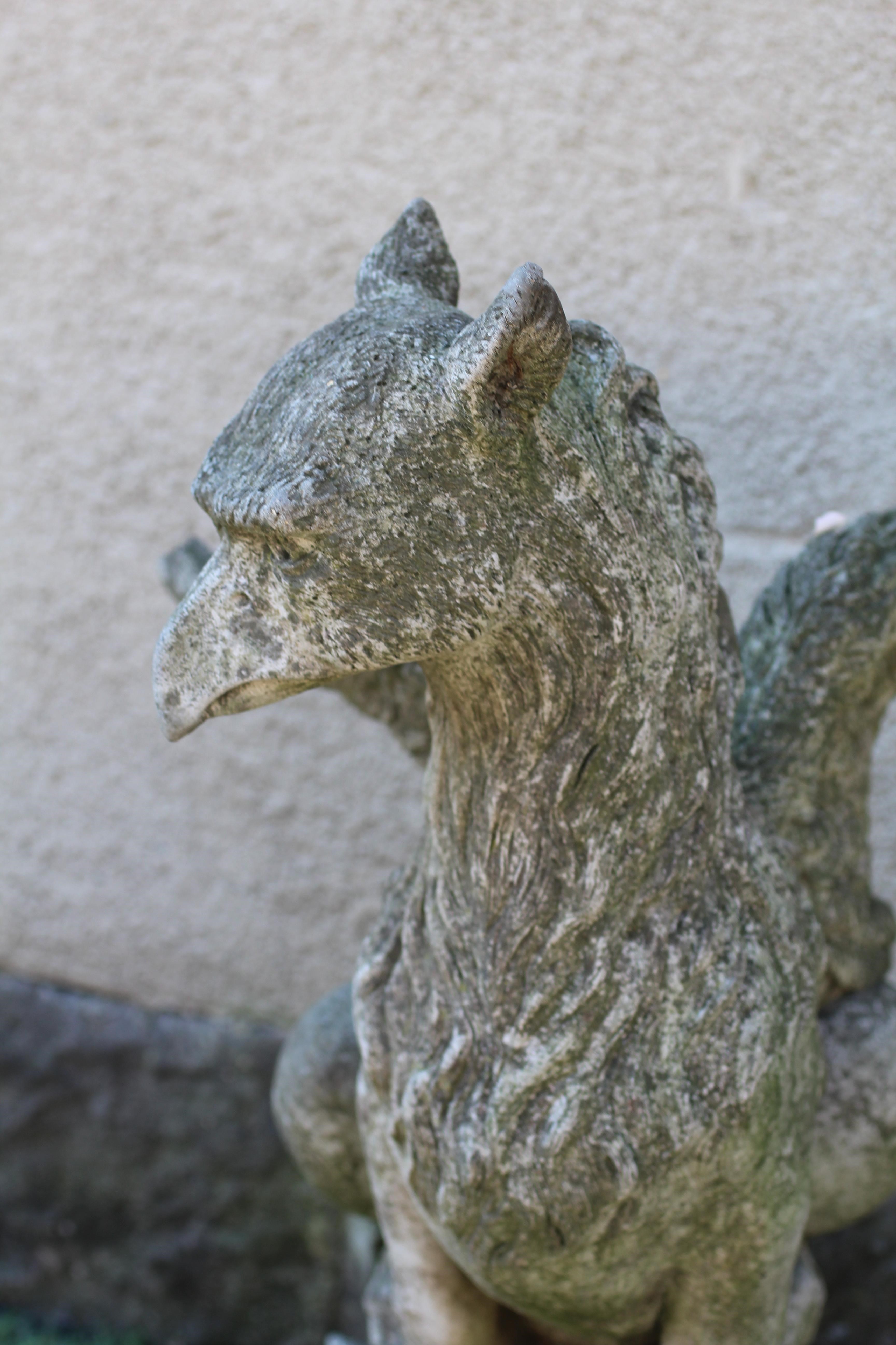 A CAST STONE GRIFFIN modelled with outstretched wings, on domed base, 16" w x 29 1/2" h Image