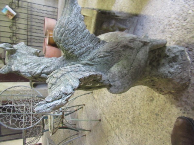 A CAST STONE GRIFFIN modelled with outstretched wings, on domed base, 16" w x 29 1/2" h Image
