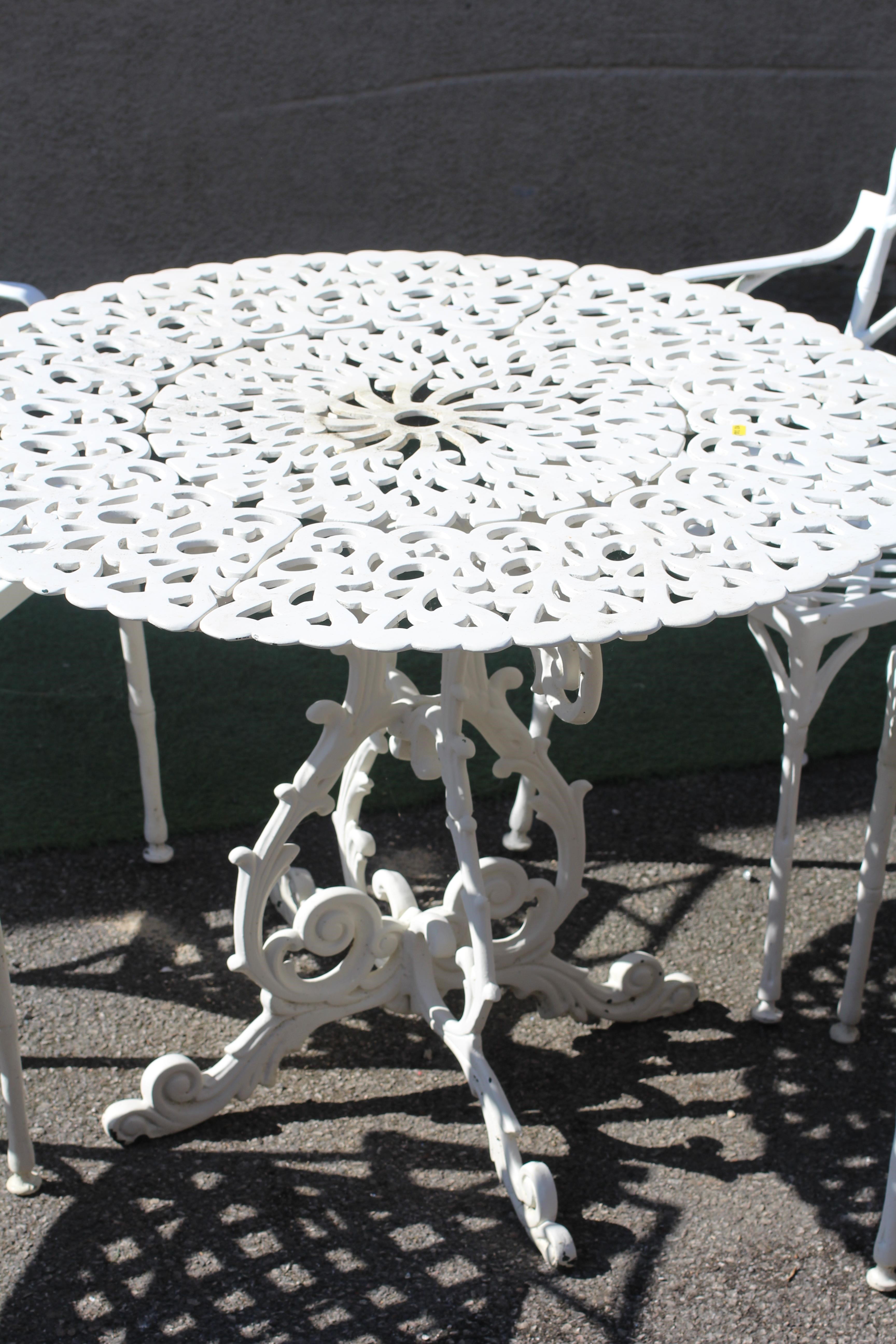 A CAST METAL DINING SUITE Image