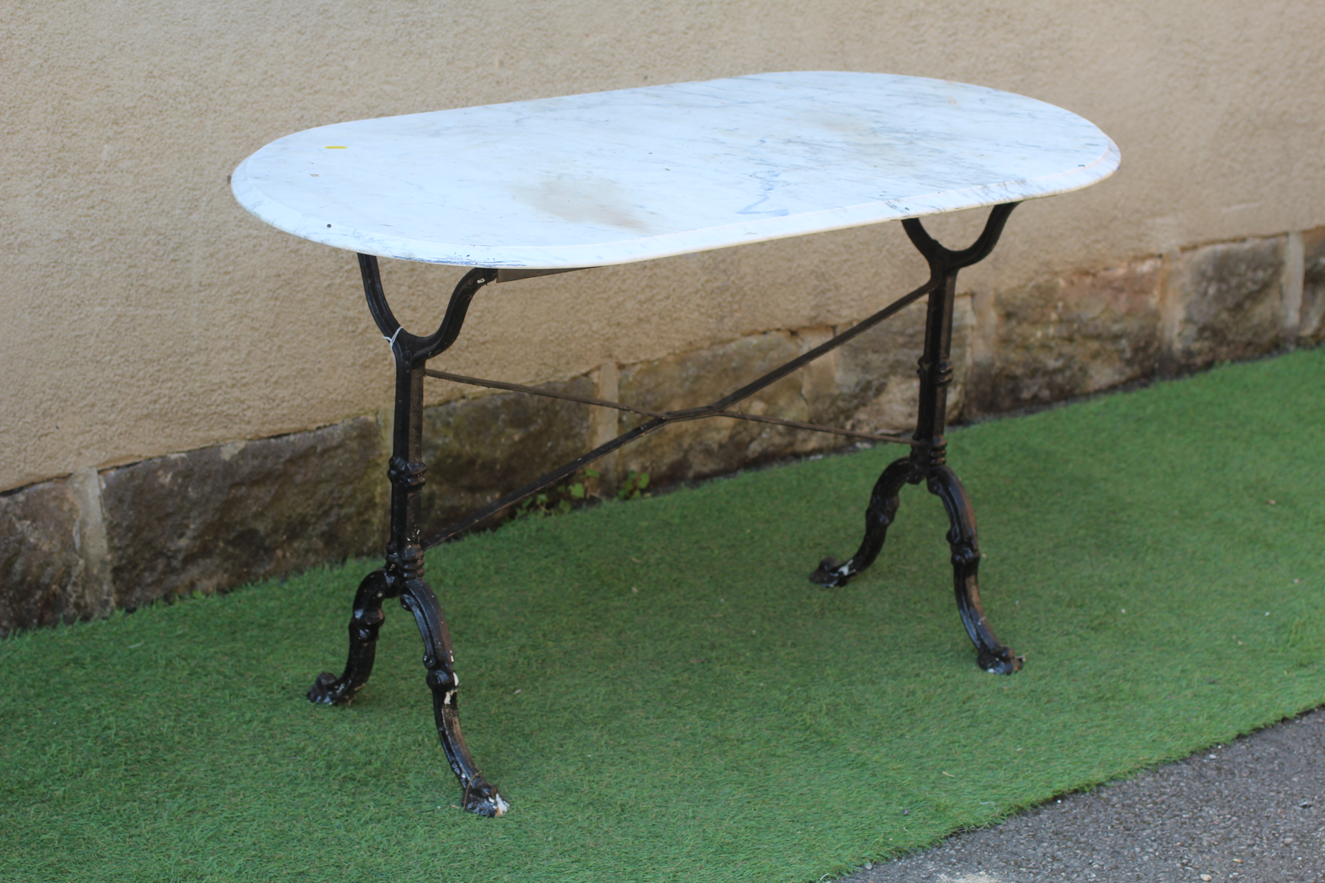 A MARBLE AND CAST IRON TABLE Image