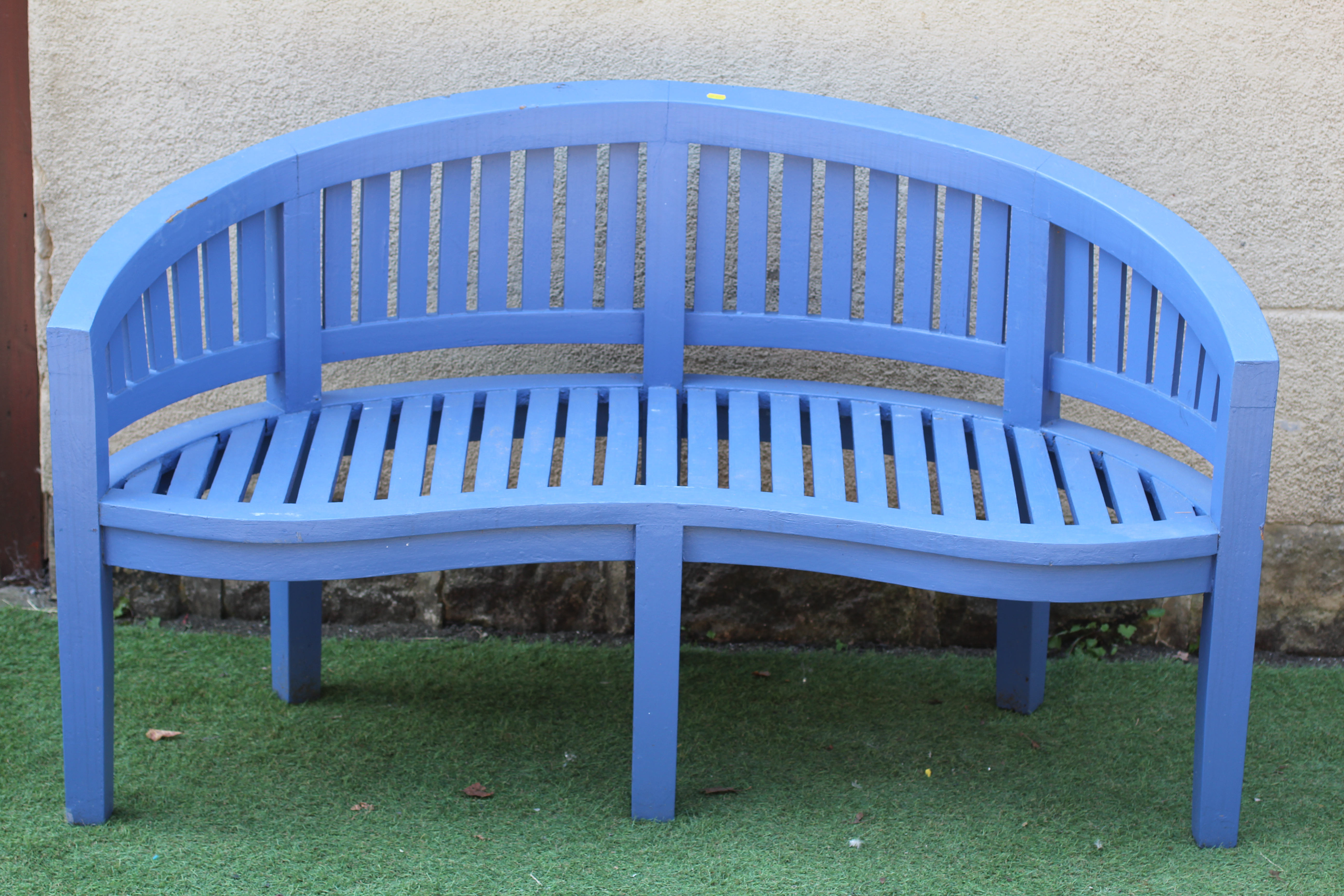 A PAINTED SLATTED HARDWOOD BENCH, modern, of curved outline with serpentine seat, mildly arched back Image